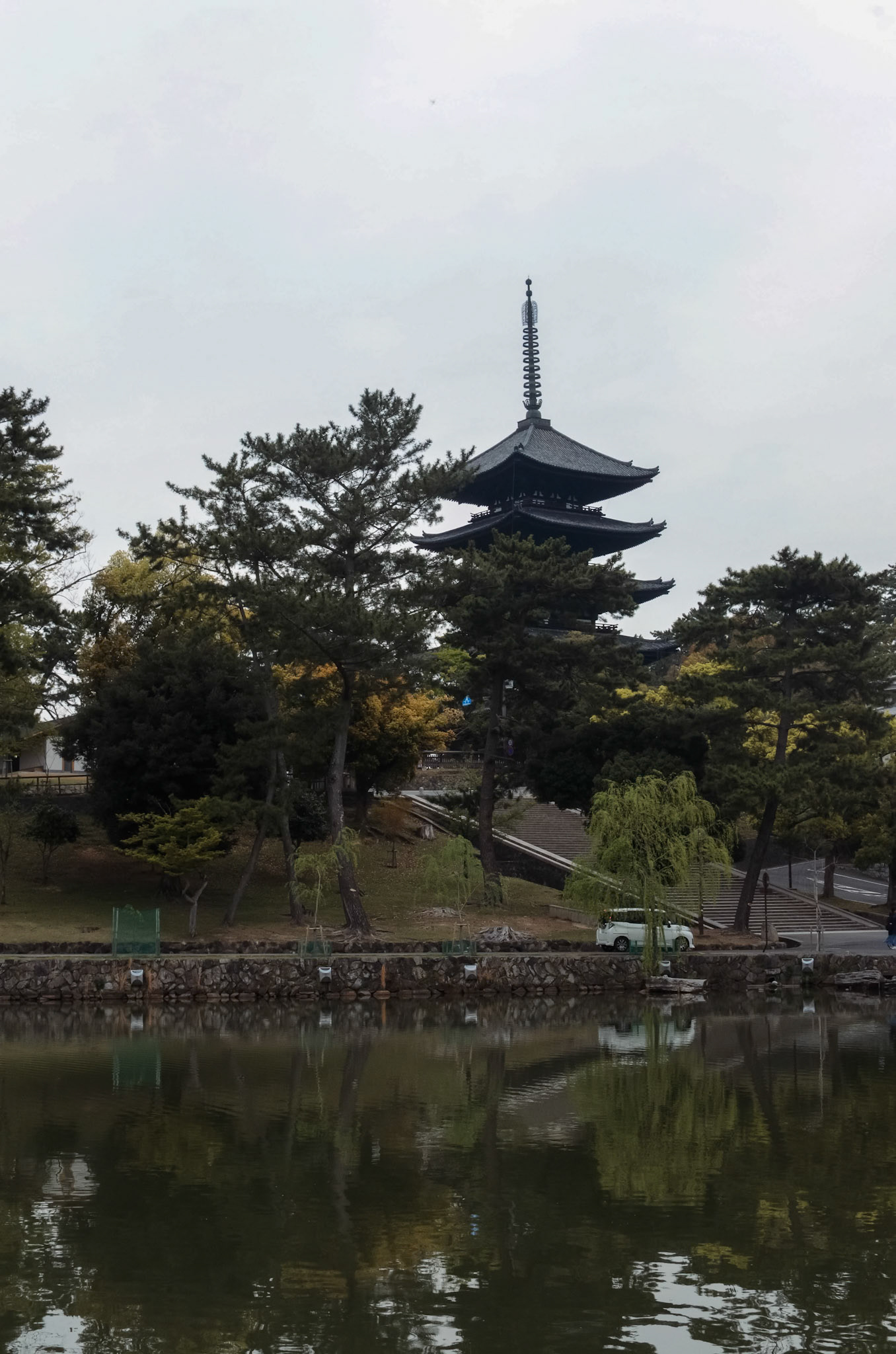 Nara Park, Nara, Japan  Nara, often known just for the bowing deer, hides some beautiful views as well. After visiting the deer, we circled Sarusawa Pond, watching the ducks glide and pigeons fly by while the Kofuku-ji Pagoda watched over us. Not much tourist yet since it was early in the morning. Just beautiful! (Plus, the deer are not as aggressive, since the deer food stalls are still closed.)  Taken with Nikon D5100