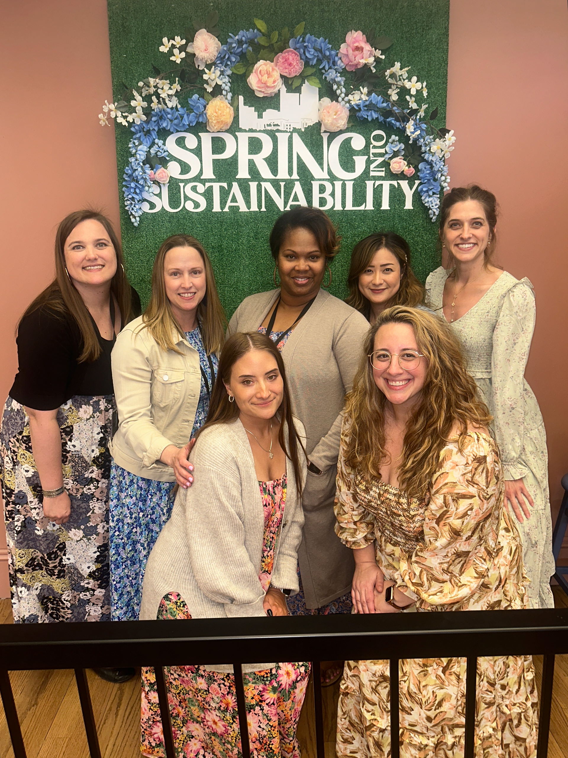 Sales and Marketing Team from the Raleigh Convention Center in front of custom photo backdrop