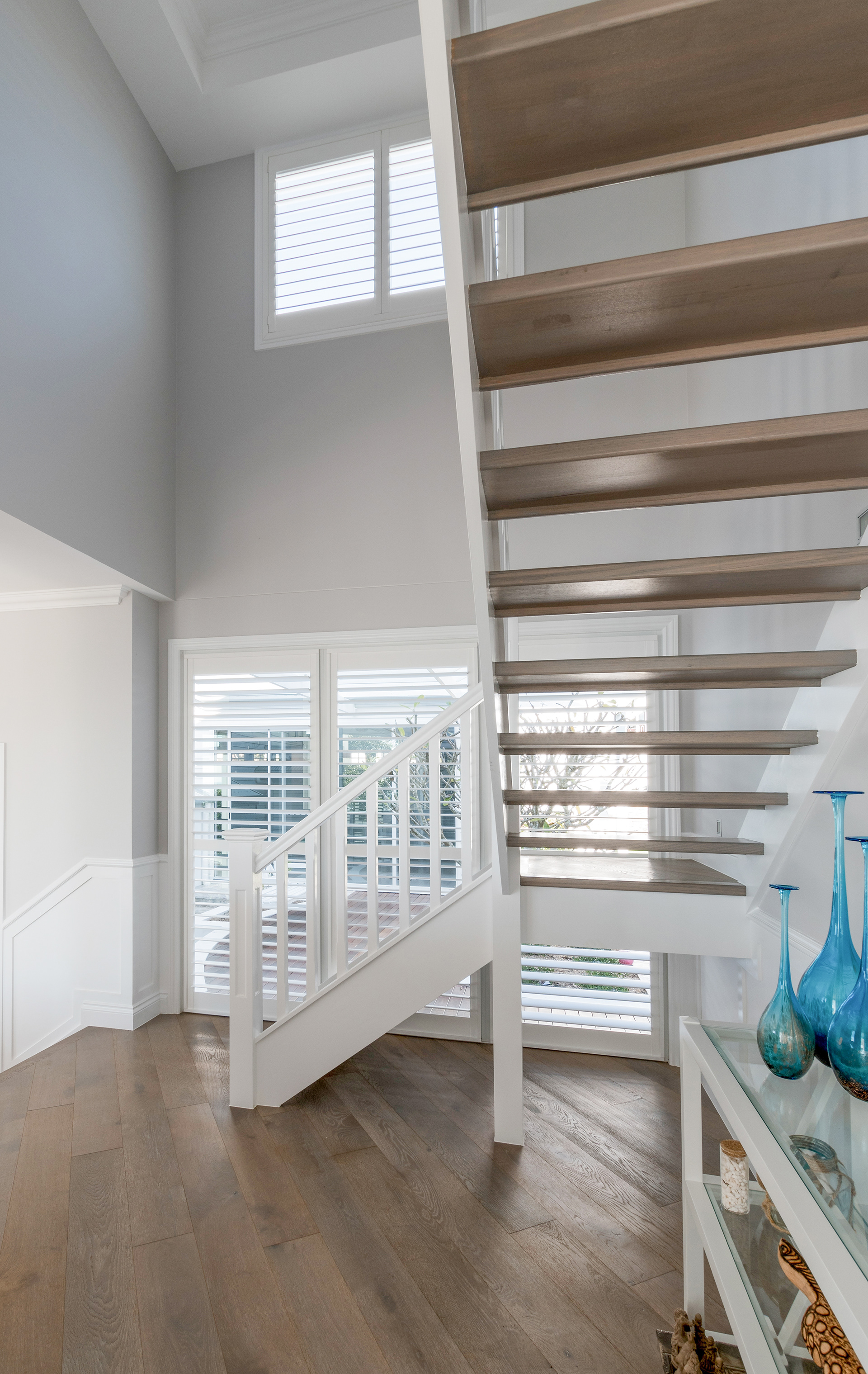 Shutters in two windows in stairwell