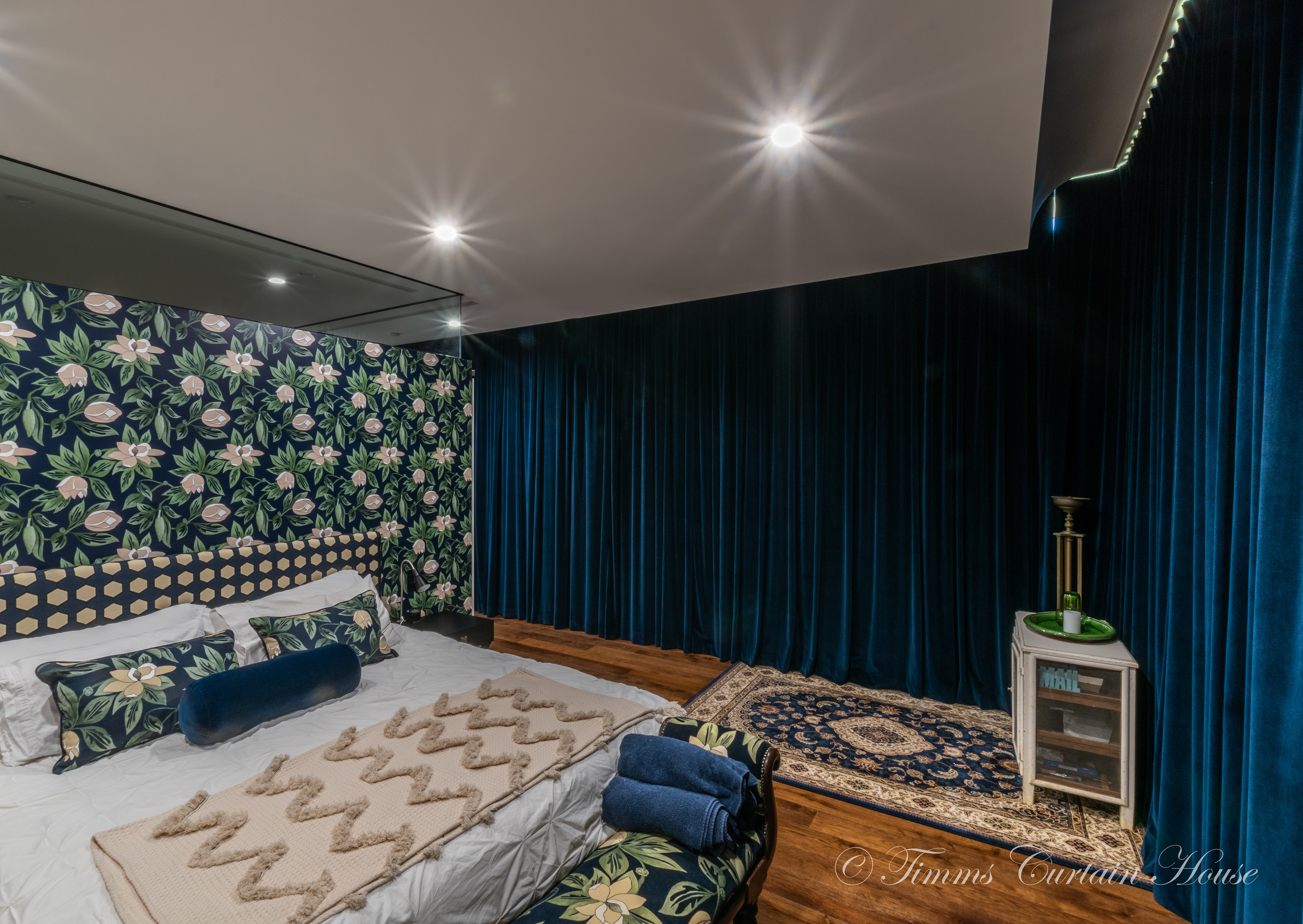 Designer fabric on the bedhead compliments the stunning wallpaper and velvet curtain