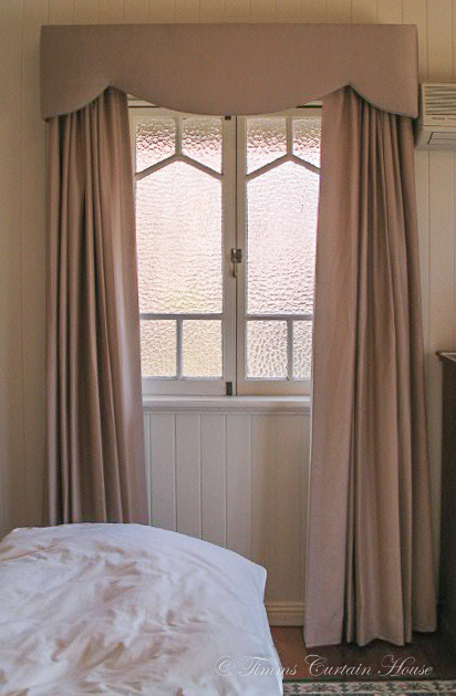 Pelmet and curtains over casement window