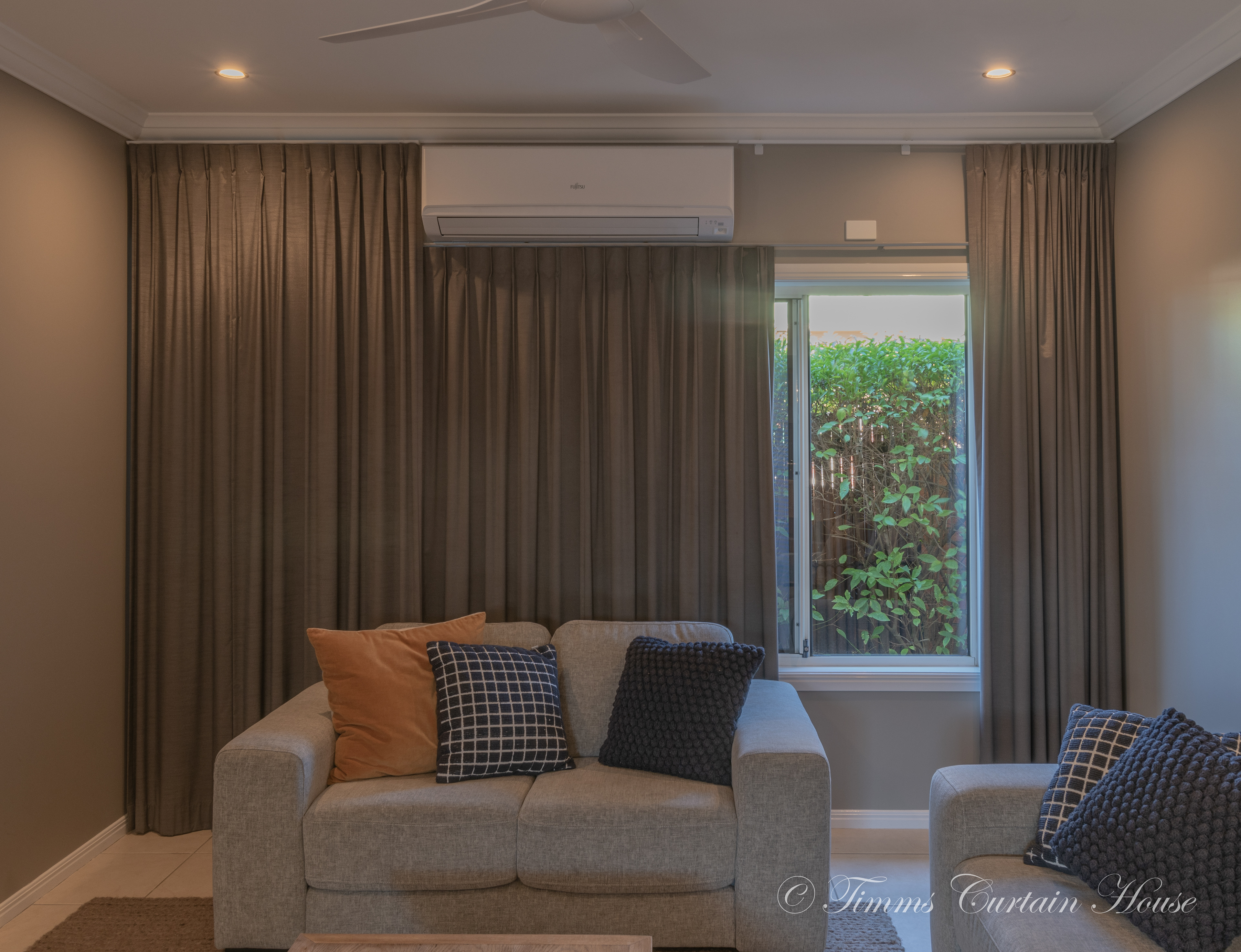 Curtains framed around air conditioner