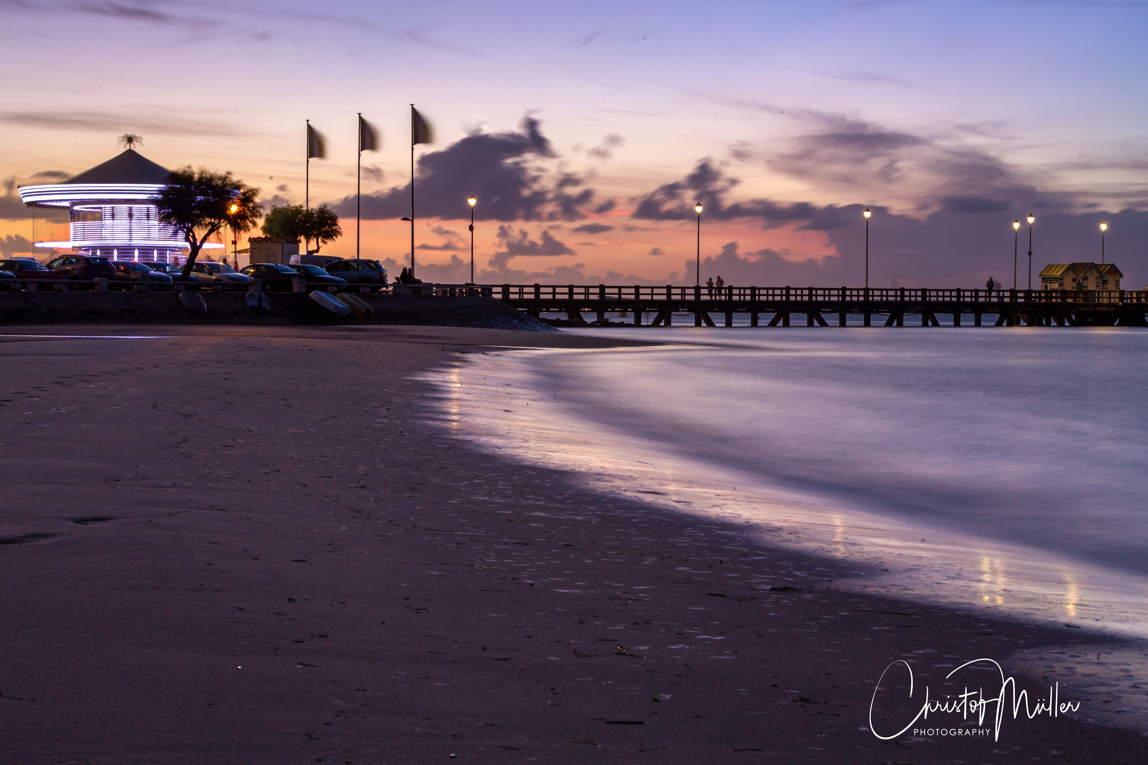 The beach, the jetty Eyrac and its carousel in Arcachon, France
