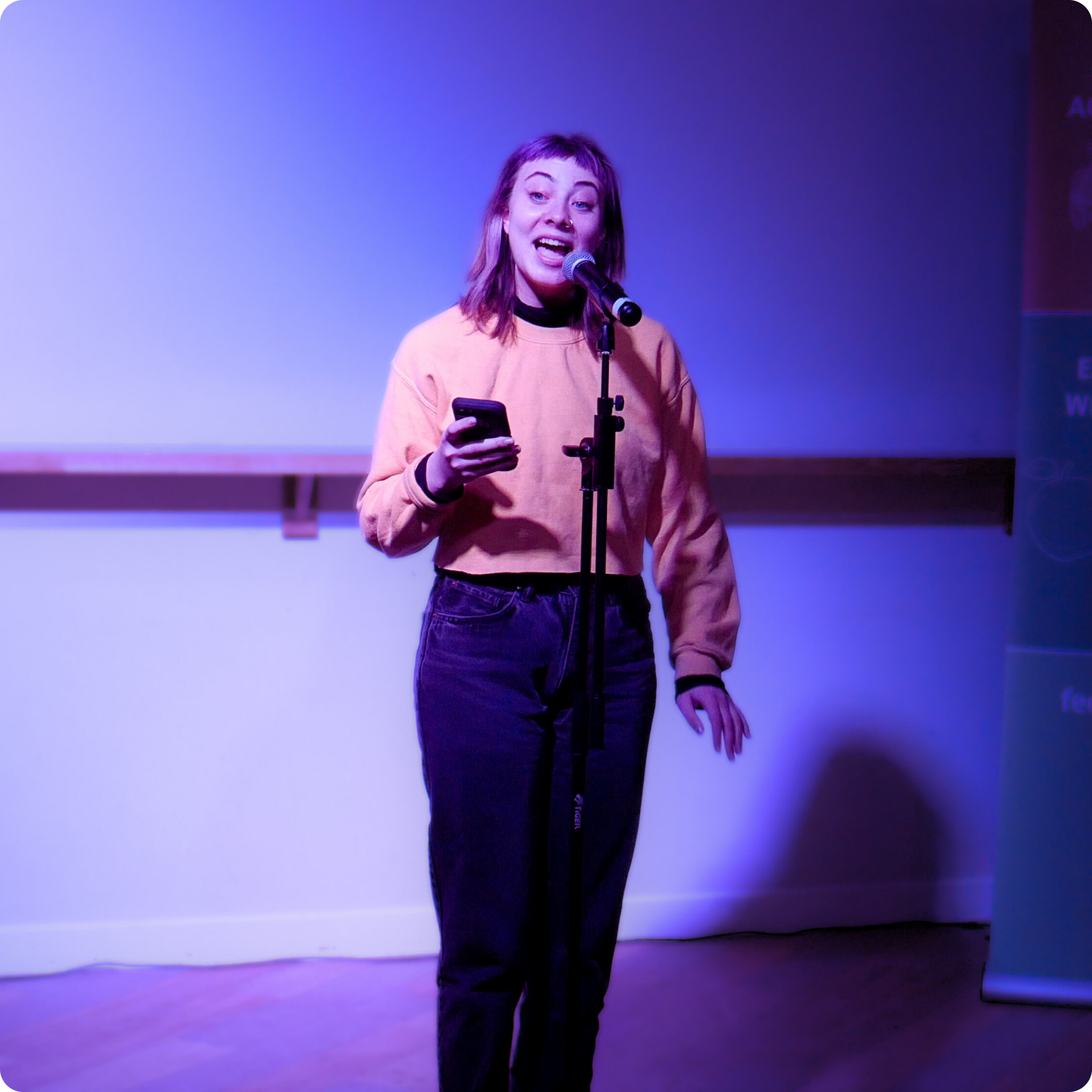 Poet and theatre-maker, Raina Greifer, holds the room captive with their striking performance prowess during Speak For Yourself: LGBT+ Poets at The Students' Union at UWE