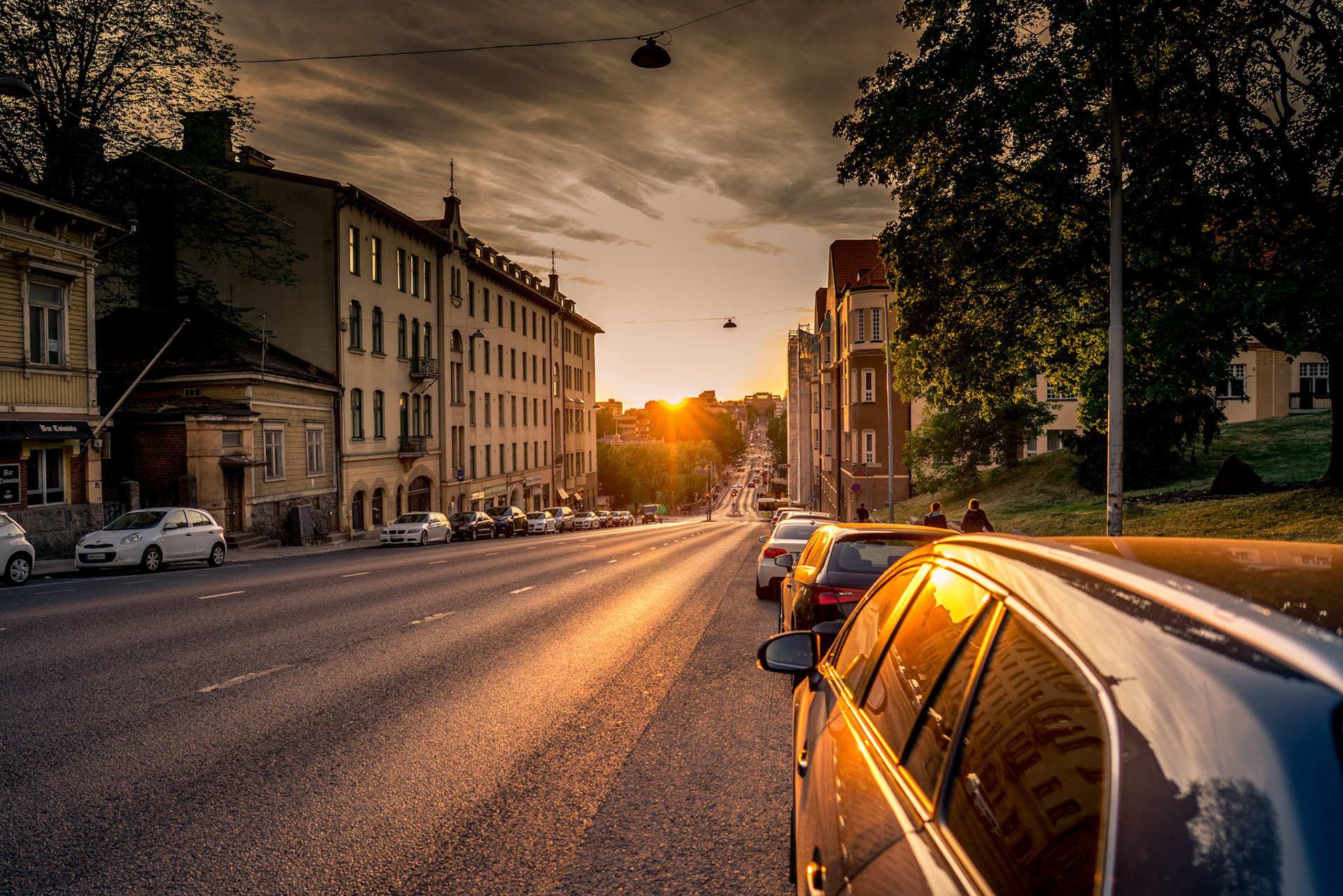 View of the sunset in ... from a downhill road on a summer day.