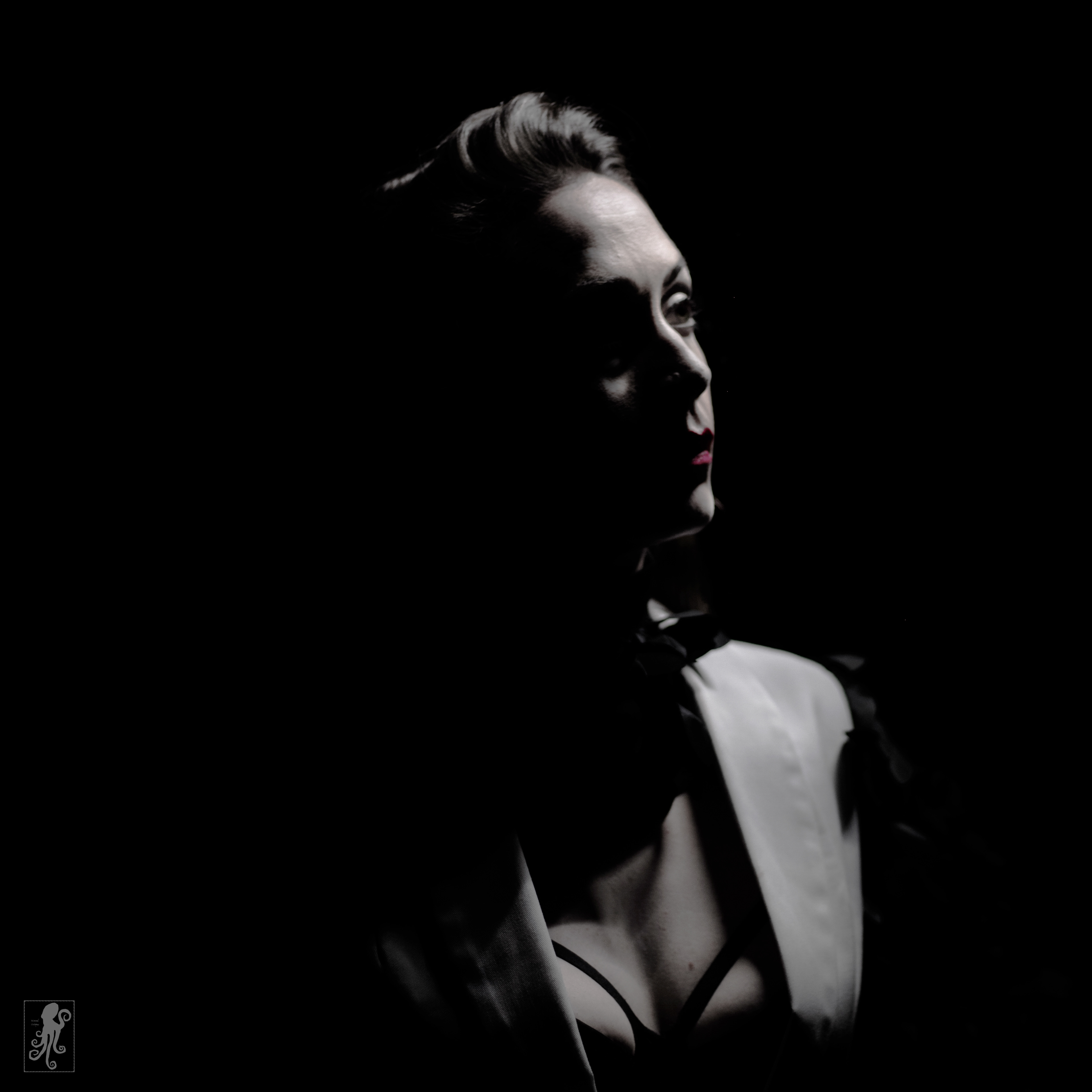 a very moody film noir style image of actor and improvisor Kathleen Burns, known for her work at Scared Scriptless and now at Perfuct Storm