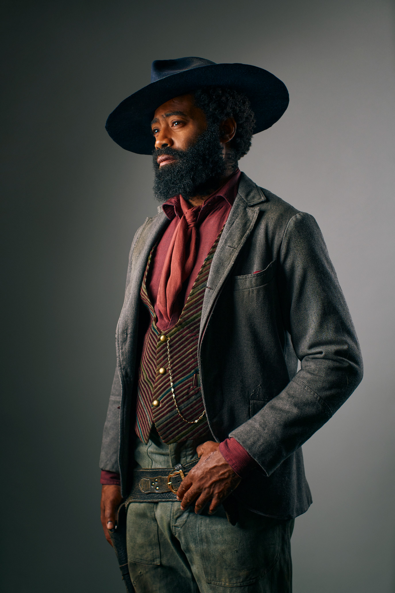 Nicholas Pinnock standing in a tailored western costume and wide-brimmed hat, photographed by Alex Gâlmeanu.