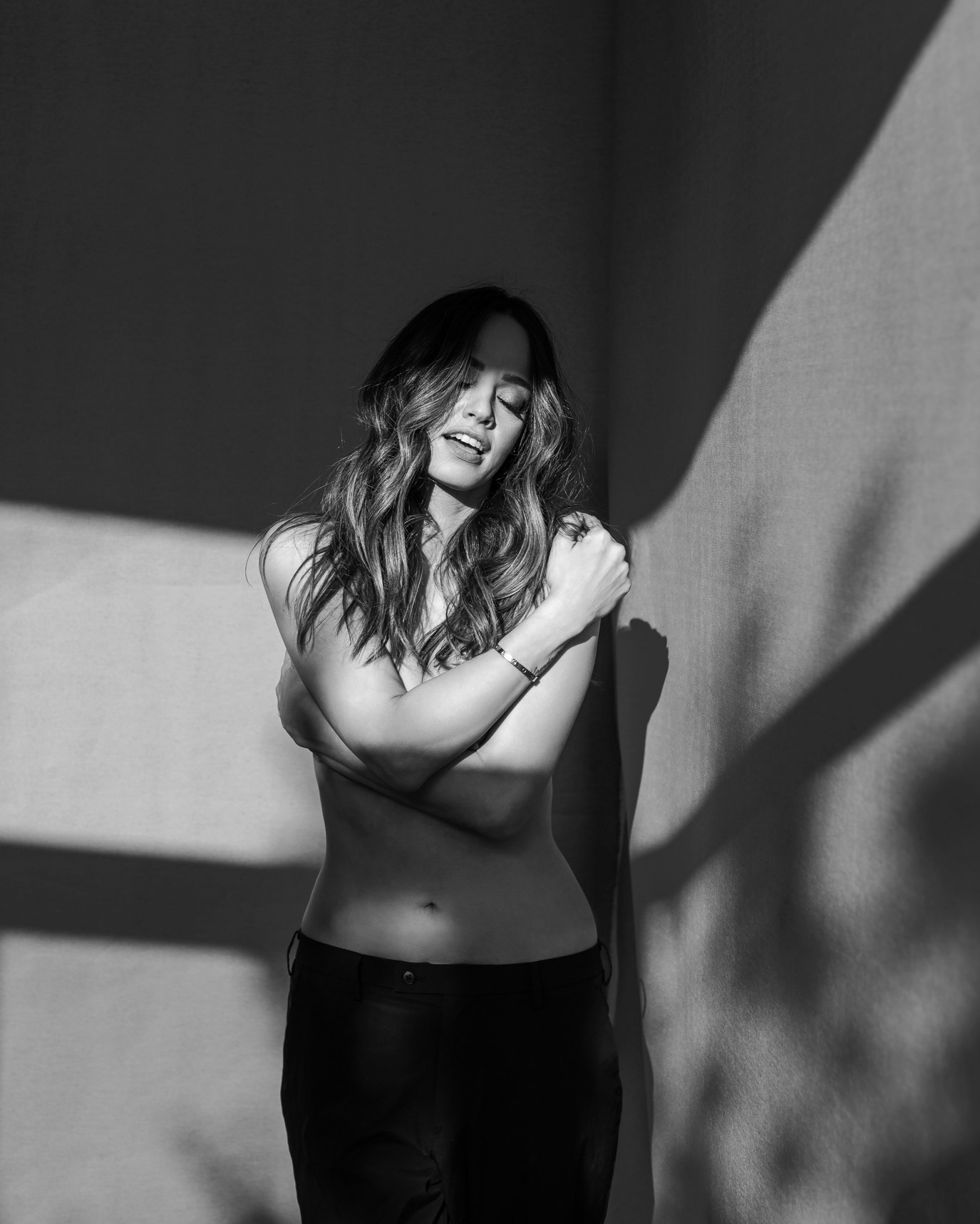 Black-and-white portrait of television host and entrepreneur Andreea Raicu laughing in hard light, photographed by Alex Gâlmeanu.