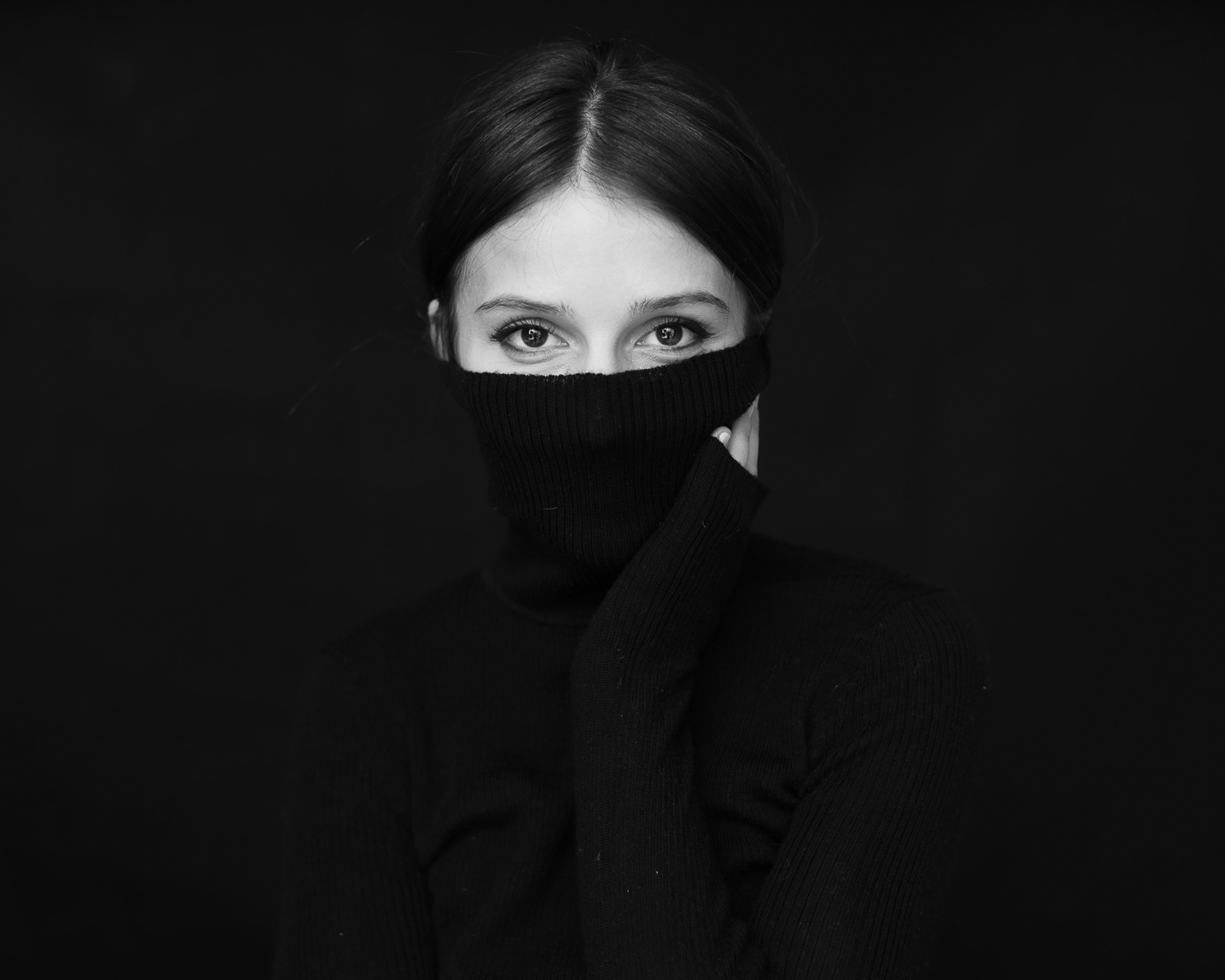 Aida Economu with a black turtleneck covering the lower half of her face, photographed by Alex Gâlmeanu.
