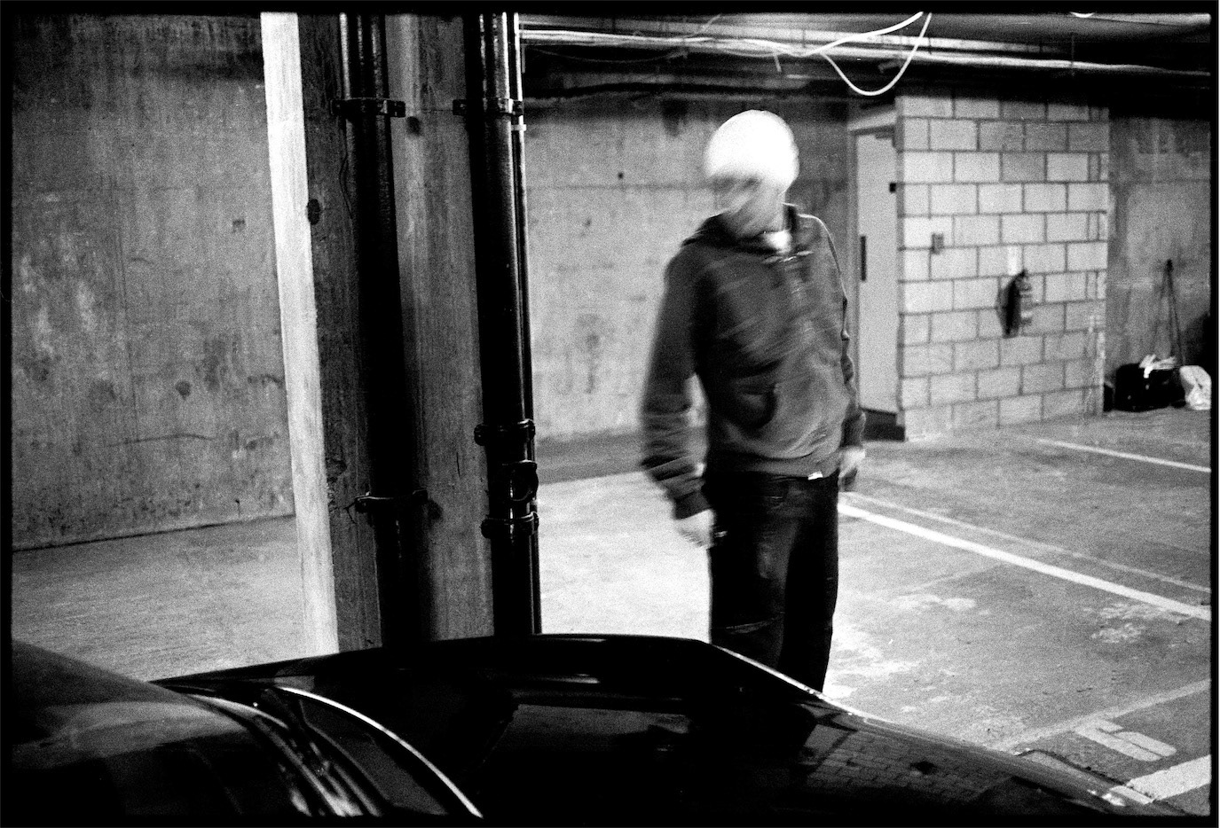 Motion-blurred black-and-white portrait of Adrian Mutu in an industrial garage, photographed by Alex Gâlmeanu.
