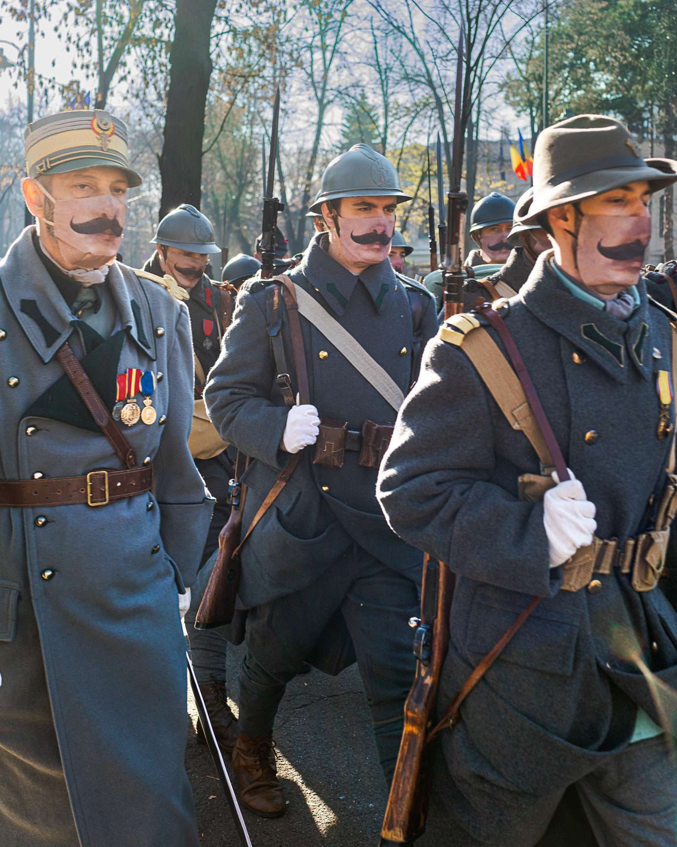 Marching soldiers wearing printed moustache masks in Bucharest, Romania. Photograph by Alex Galmeanu.