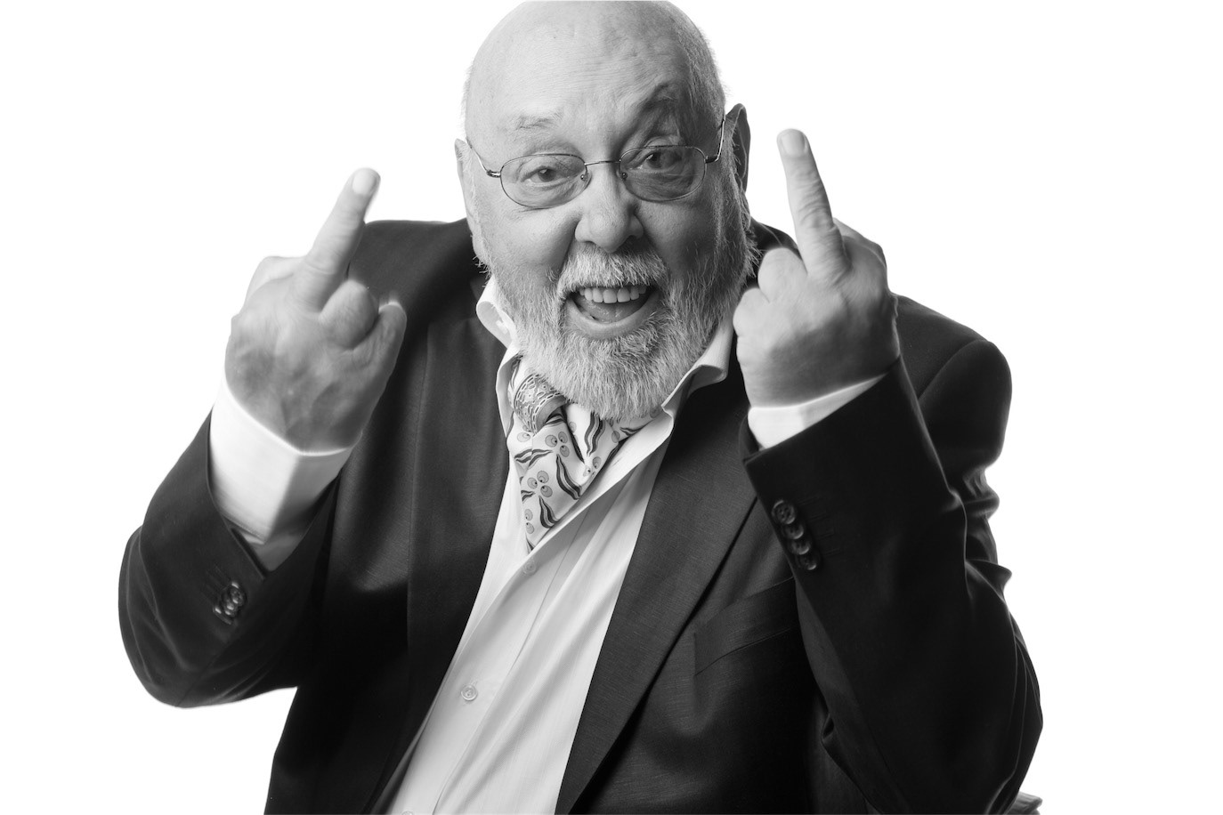 Black-and-white portrait of Johnny Răducanu smiling and raising both middle fingers, photographed by Alex Gâlmeanu.