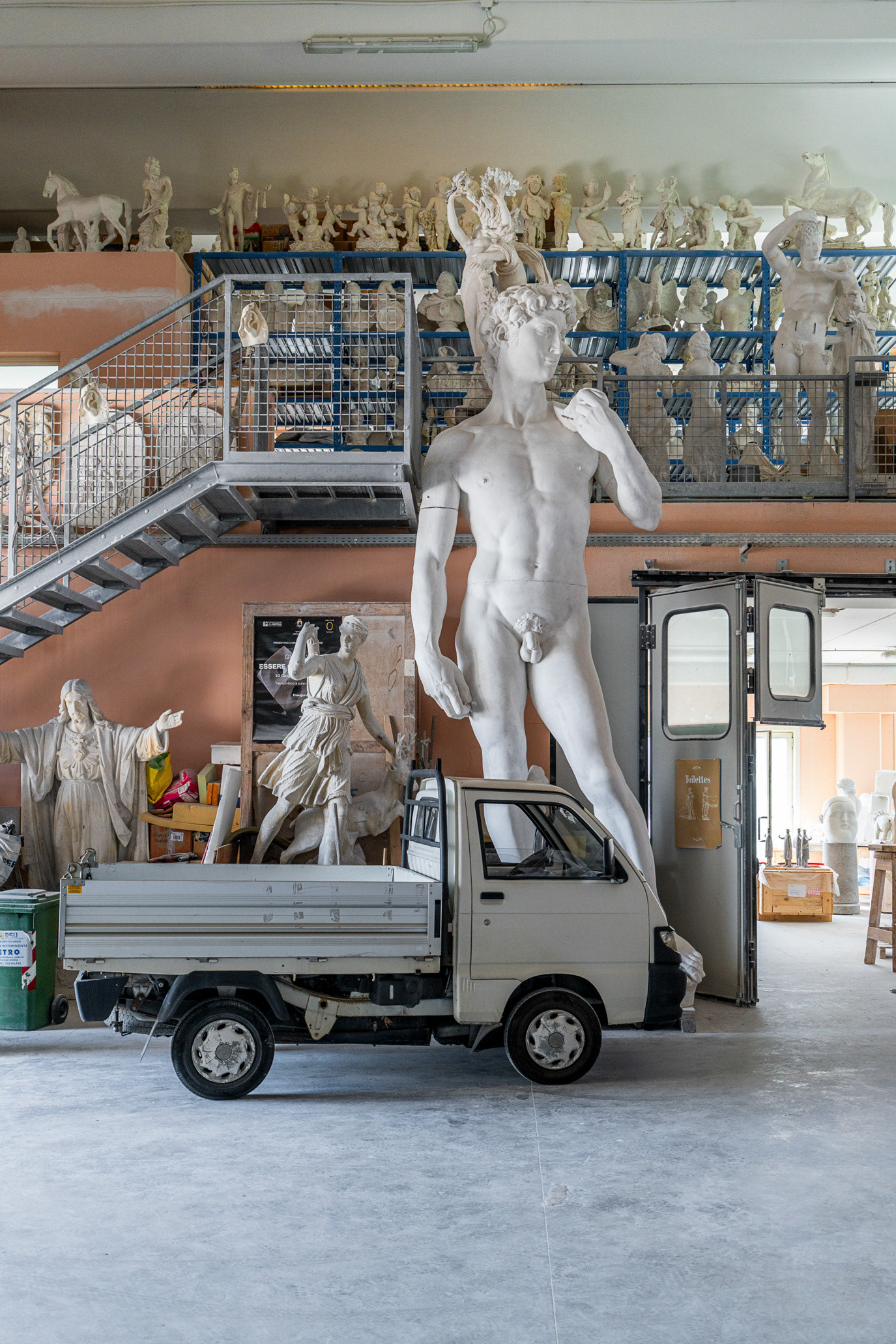 A monumental white sculpture transported on a small truck in Pietrasanta, Italy. Photograph by Alex Galmeanu.