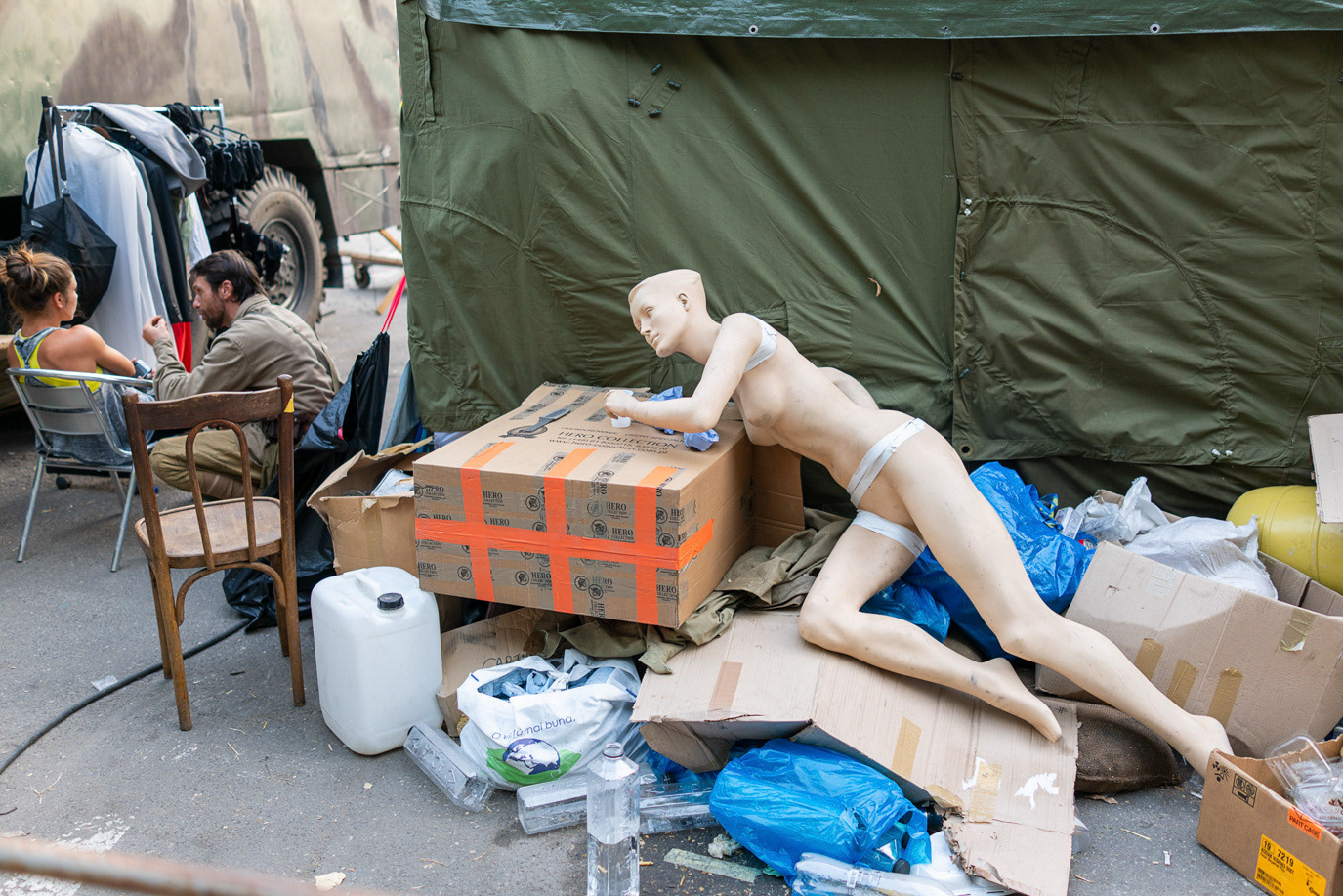 A discarded mannequin resting among market boxes and debris in Bucharest, Romania. Photograph by Alex Galmeanu.