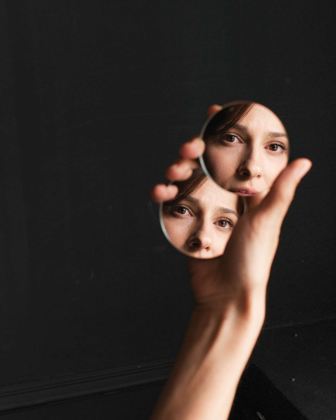 Portrait of actor Dana Rogoz seen through small circular mirrors that fragment her face, photographed by Alex Gâlmeanu.
