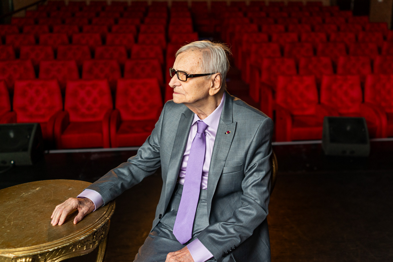 Portrait of actor Radu Beligan seated in an empty theatre, photographed by Alex Gâlmeanu.