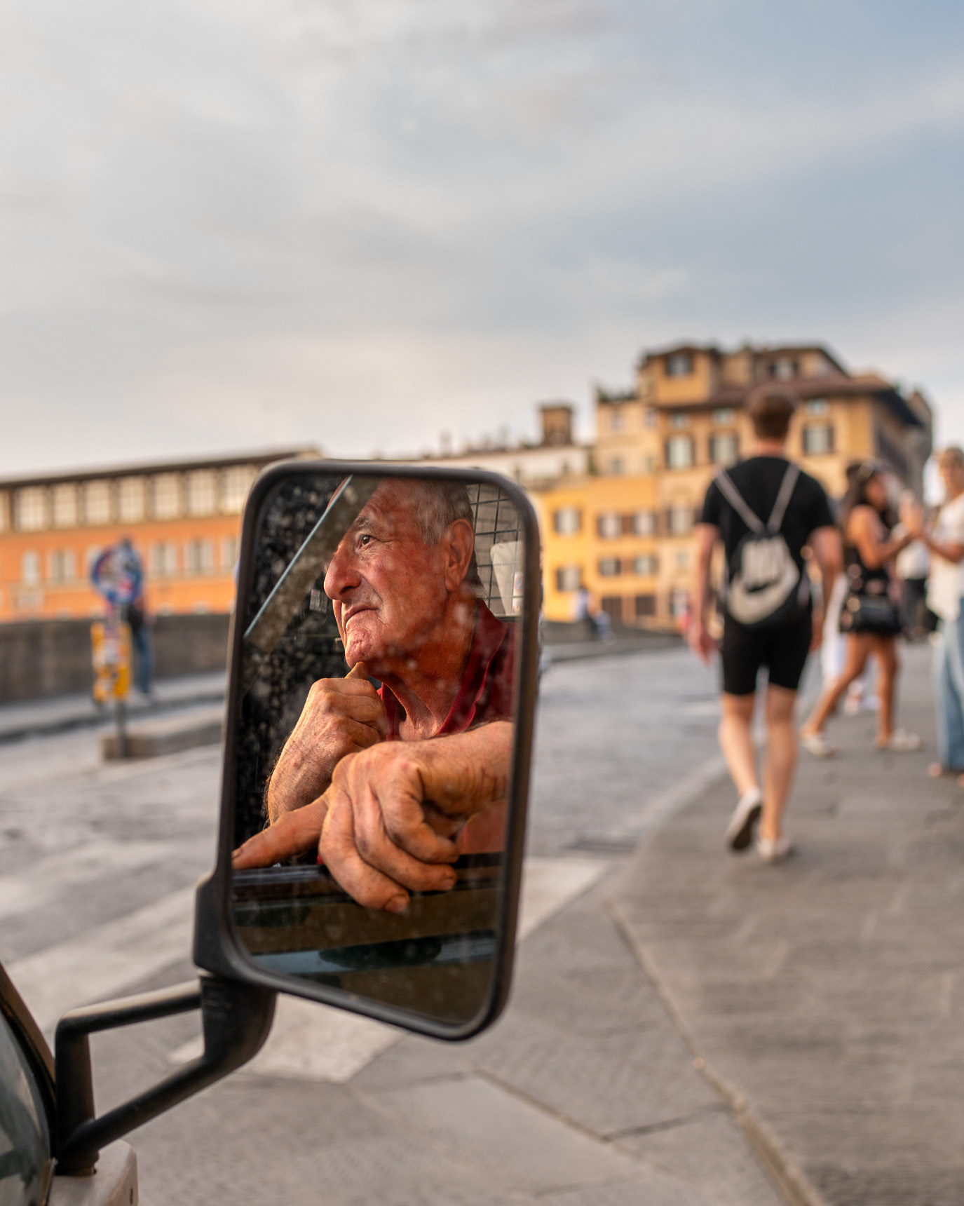 A man’s face reflected in a scooter mirror in Florence, Italy. Photograph by Alex Galmeanu.