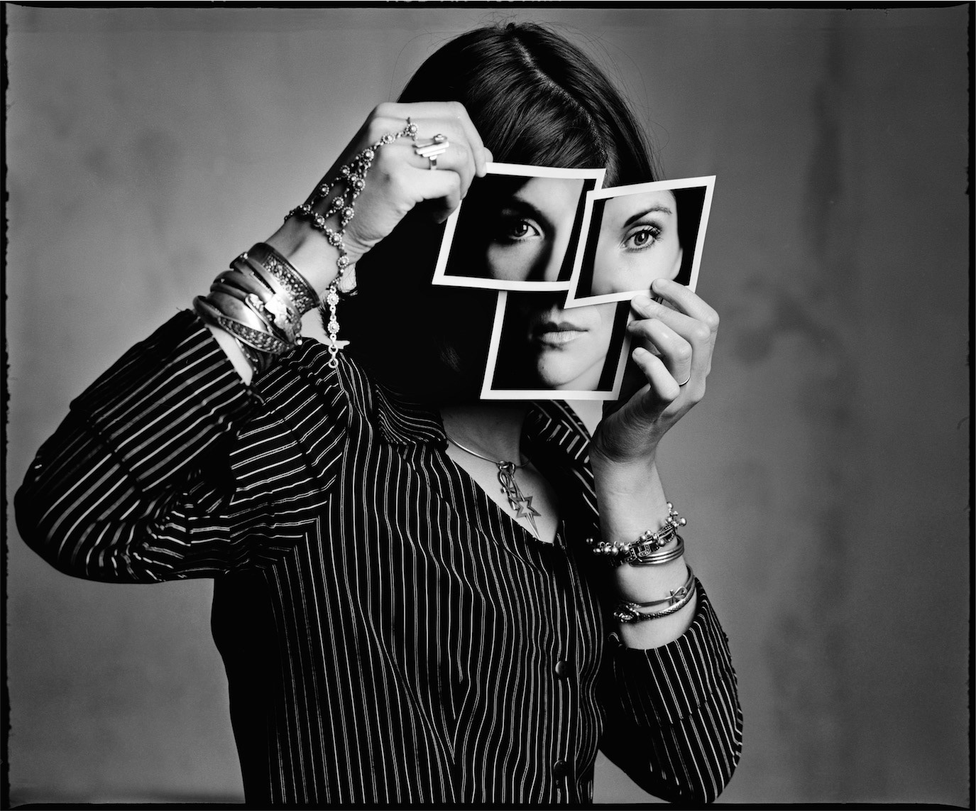 Chris Simion holding cut-out images of eyes and lips over her face, photographed by Alex Gâlmeanu.