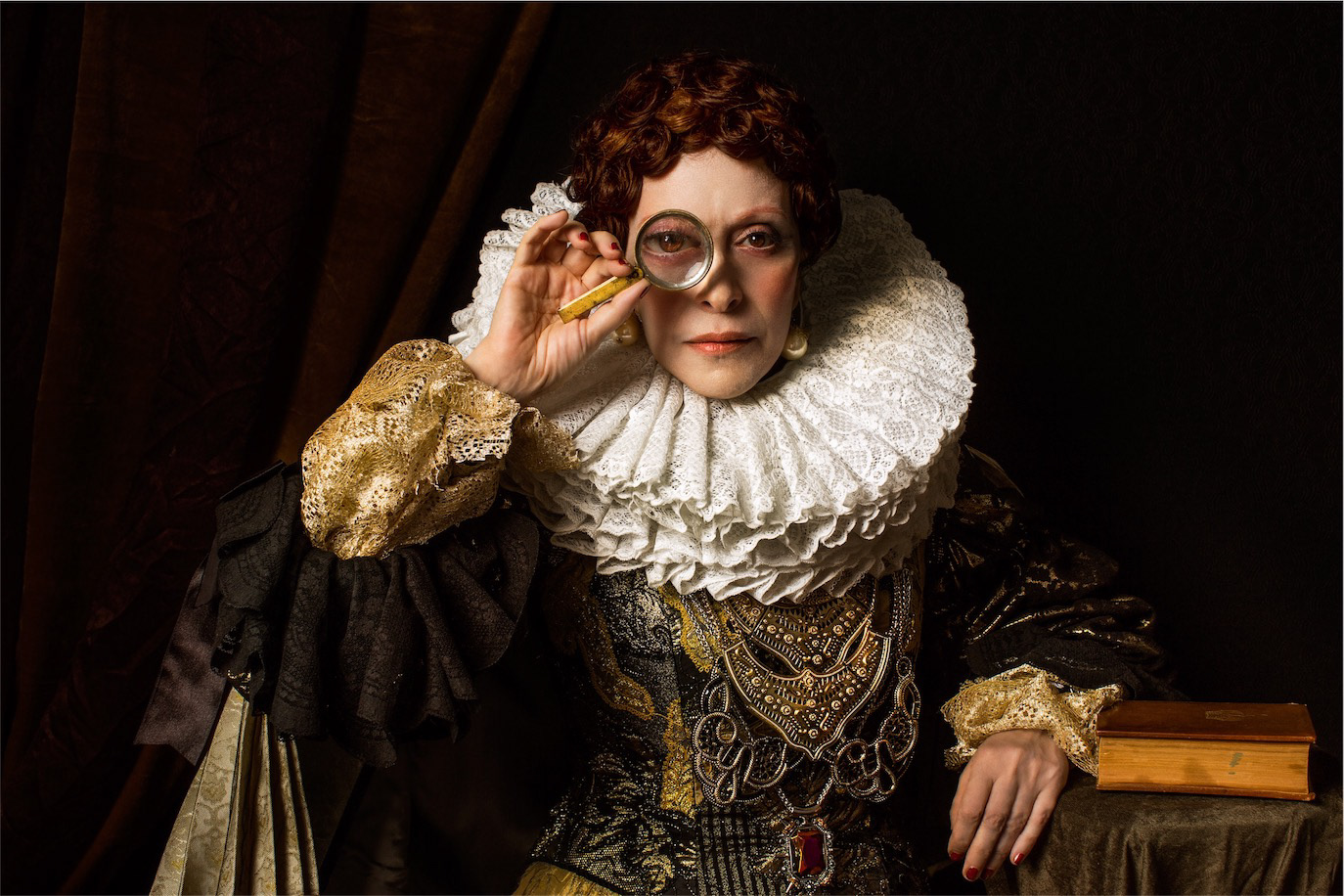 Princess Lia in historical costume holding a magnifying glass to one eye, photographed by Alex Gâlmeanu.