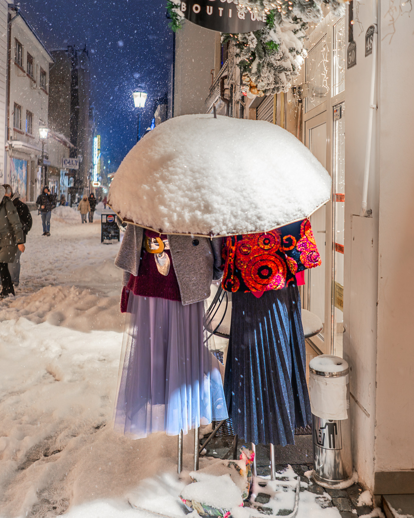 A snow-covered outdoor clothing rack on a Bucharest street in Romania. Photograph by Alex Galmeanu.