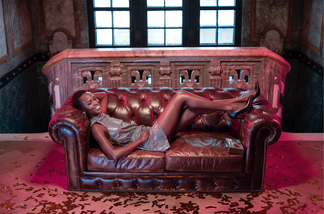 Fashion Days campaign featuring two models reclining on a leather sofa in an industrial interior, photographed by Alex Galmeanu.