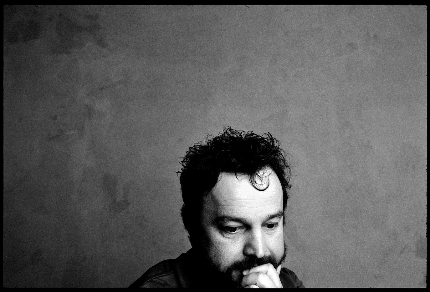 Gyuri Pascu appearing low in the frame in a contemplative black-and-white portrait, photographed by Alex Gâlmeanu.