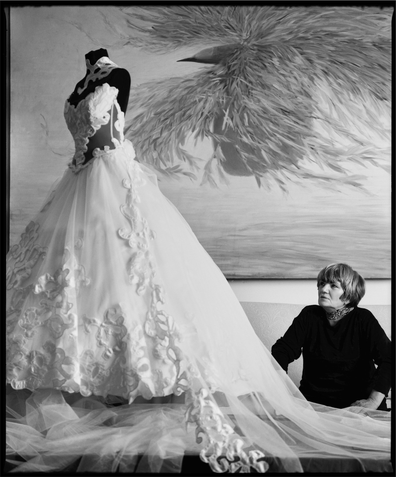 Doina Levintza seated beside a voluminous white gown in a black-and-white studio portrait, photographed by Alex Gâlmeanu.