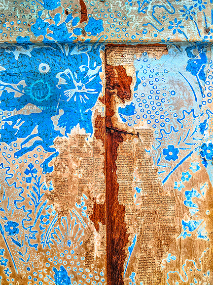 Decay - Taken inside an abandoned home, this image reveals layered wallpapers and reinforced wood beneath. Shaped by water and time, the structure reflects both deterioration and the quiet strength that endures within.  ($700)