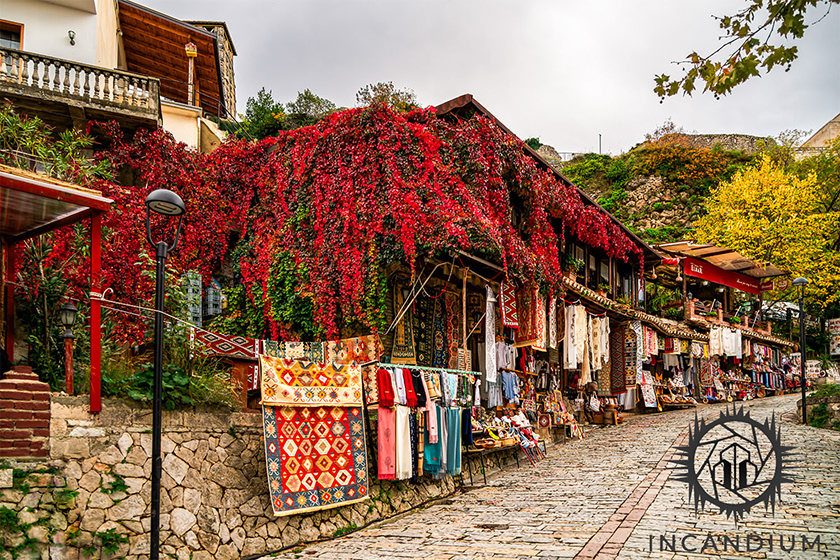 A Day at the Market, Krujë - Under a cloudy sky, the market’s colors deepen and intensify. In a rare quiet moment, the street stands empty, allowing the region’s artisanal tradition and layered history-central to Albania’s identity-to speak without interruption. ($500)