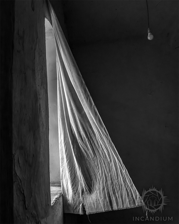 Light Turns on Light - Photographed at the Museum of Arms and Prison in Gjirokastër, Albania, this open window admits light and wind into a space heavy with memory. The moving curtain suggests release-illumination and air working together to ease the weight of a turbulent past.  ($130)