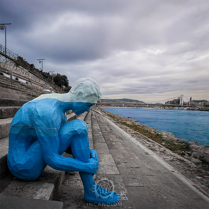 Held in Blue - The human figure sits in balance, echoing our physical and mental dependence on water. Though colorless in nature, water is imagined as blue here, reflecting its essential presence in both body and thought. ($100)