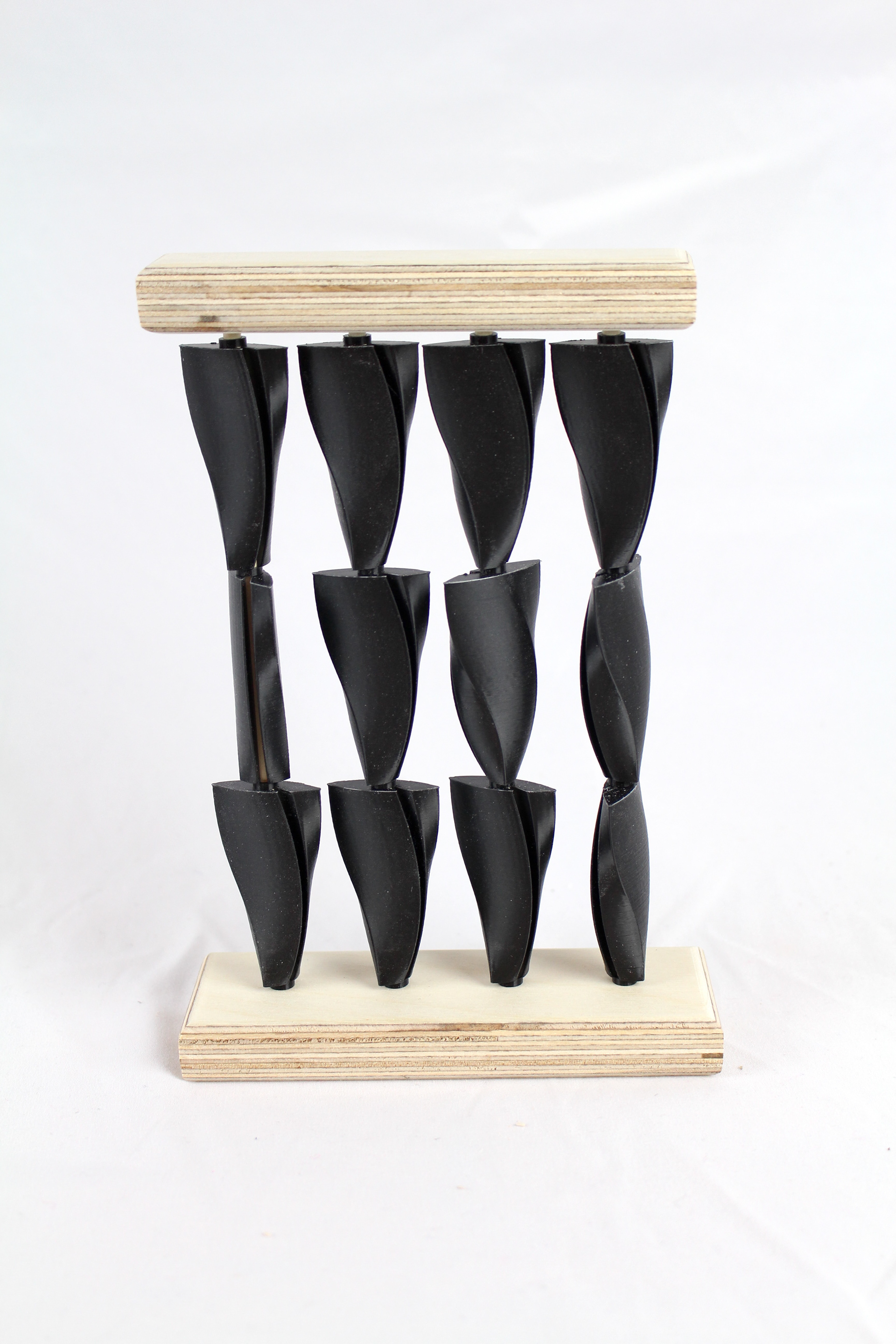 Shots of small scale 3d printed PLA and wood models showcasing the arrangements of the three different finalized shapes.