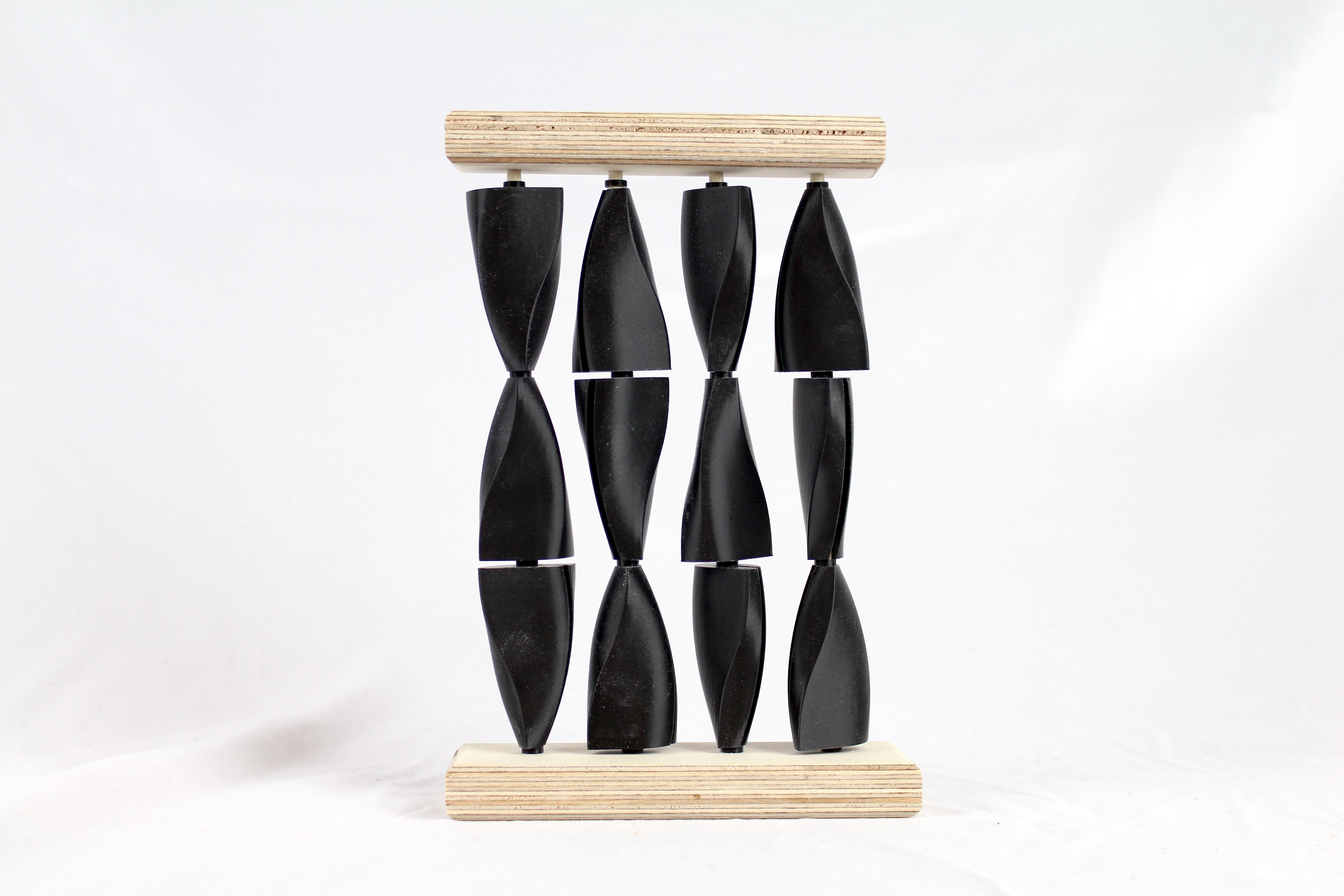 Shots of small scale 3d printed PLA and wood models showcasing the arrangements of the three different finalized shapes.