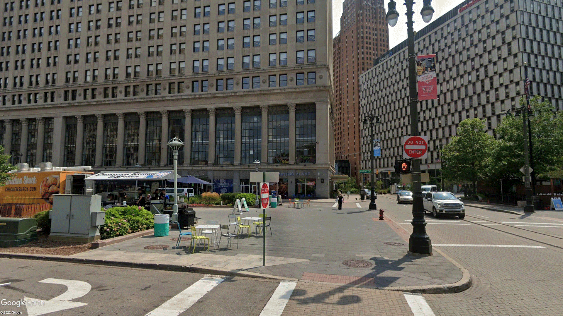 This image shows an alternative usage of the Cadillac Square Park space directly in front of the First National Building. More vegetation has been added to place the space in dialogue with the ongoing plans of greenifying the city. Additional retail spaces have been added to exemplify the growing number of locally-owned businesses, along with a diverse grouping of human models. The scene also showcases the possible future of Detroit with a stormy sky and water emanating from the Detroit River, highlighting the forecasted effects of global warming in the state.