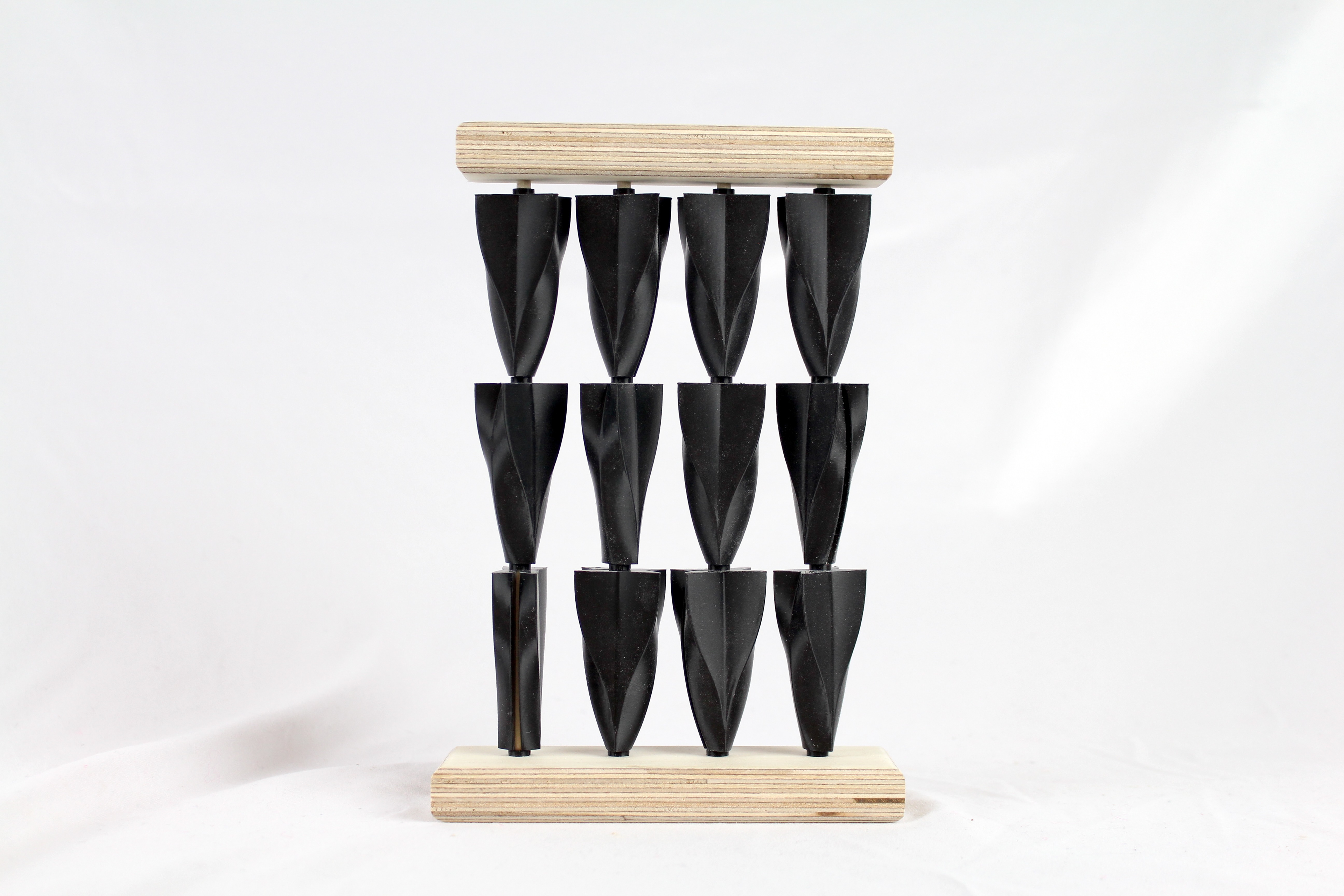 Shots of small scale 3d printed PLA and wood models showcasing the arrangements of the three different finalized shapes.