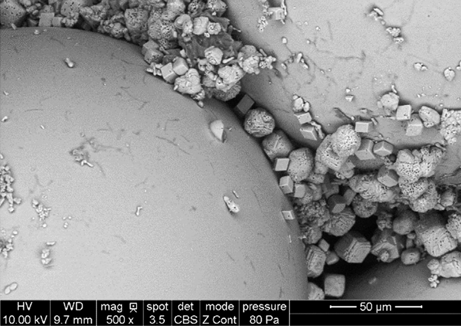 SEM images of MICP-treated glassbeads with precipitated calcite minerals | Reprinted from "Review on geotechnical engineering properties of sands treated by microbially induced calcium carbonate precipitation (MICP) and biopolymers"