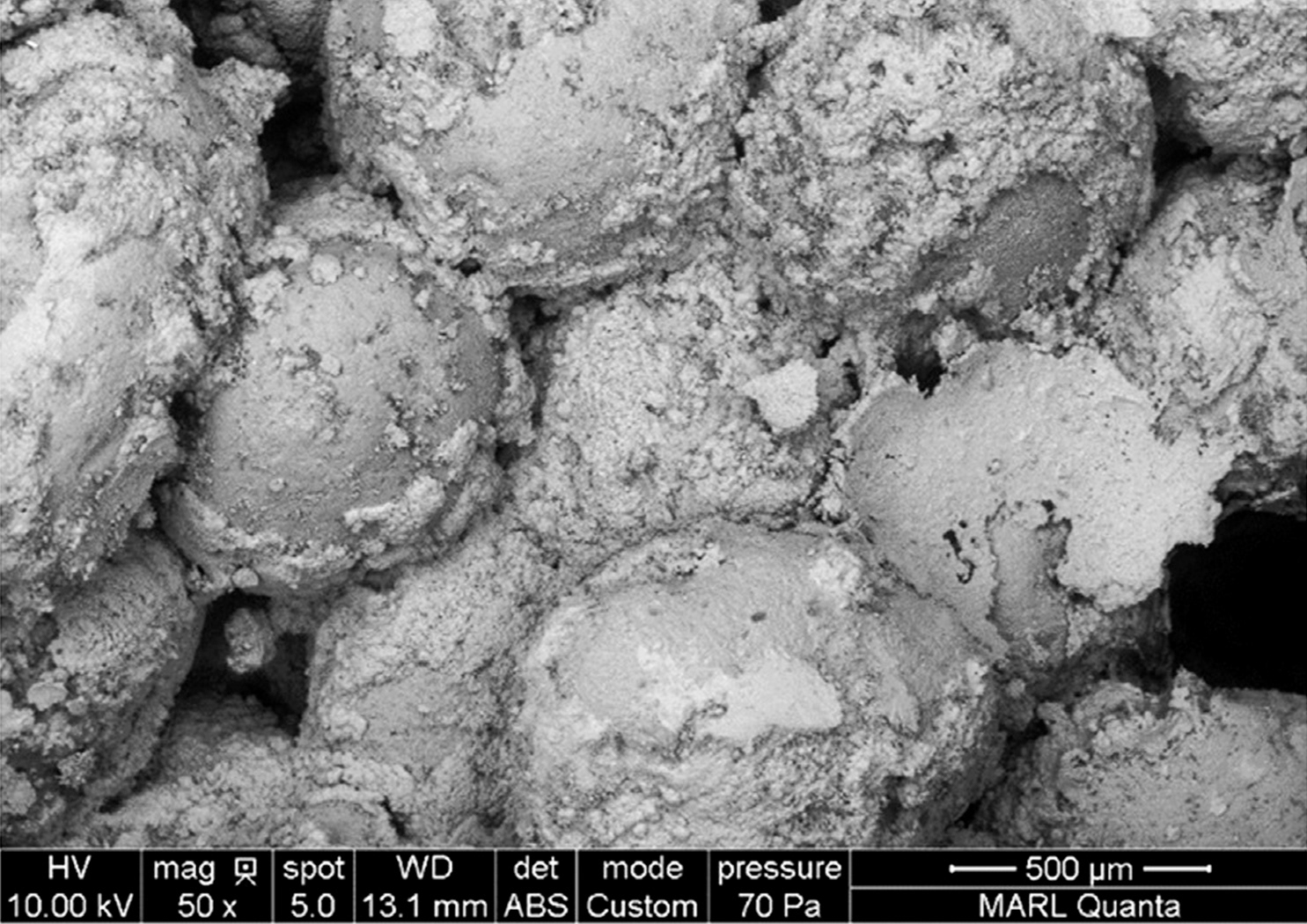 SEM images of MICP-treated sand grains coated with calcite | Reprinted from "Review on geotechnical engineering properties of sands treated by microbially induced calcium carbonate precipitation (MICP) and biopolymers"