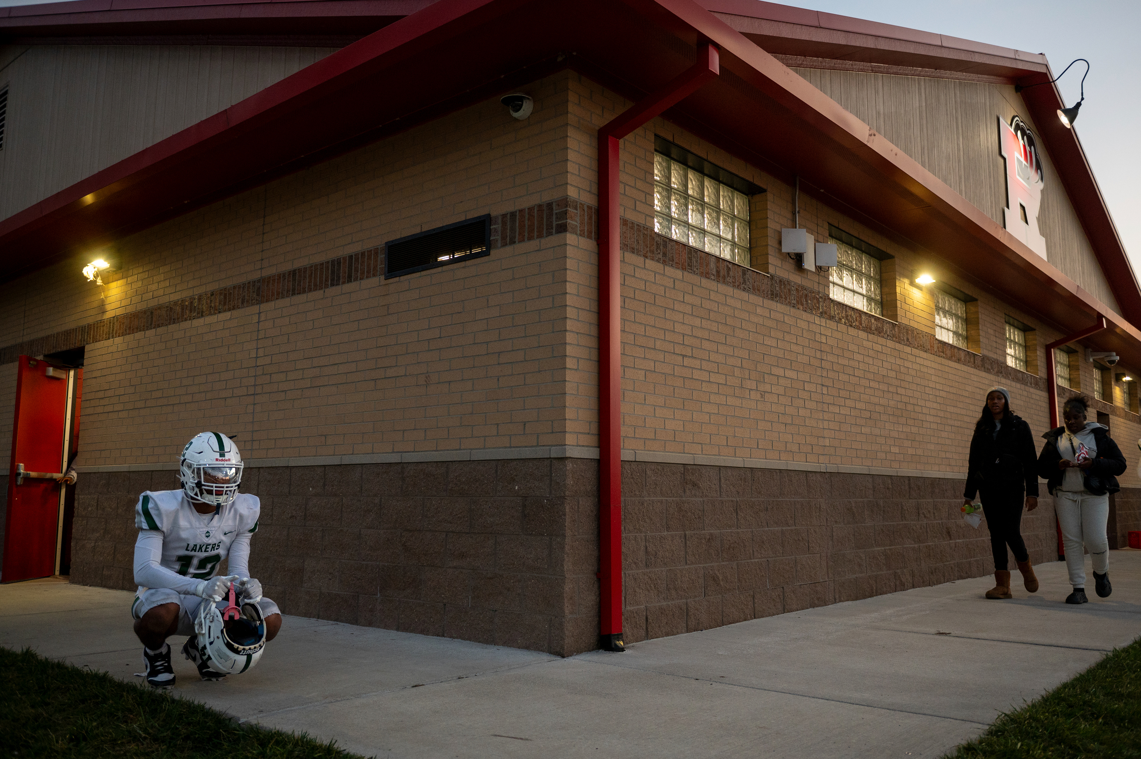 Junior defensive back Will Espy (12) of West Bloomfield High School sits in the locker room while waiting for a teammate before a game against the Roseville Panthers at Roseville High School in Roseville, Mich., on Friday, Oct. 25, 2025. The game marked the final contest of the regular season.