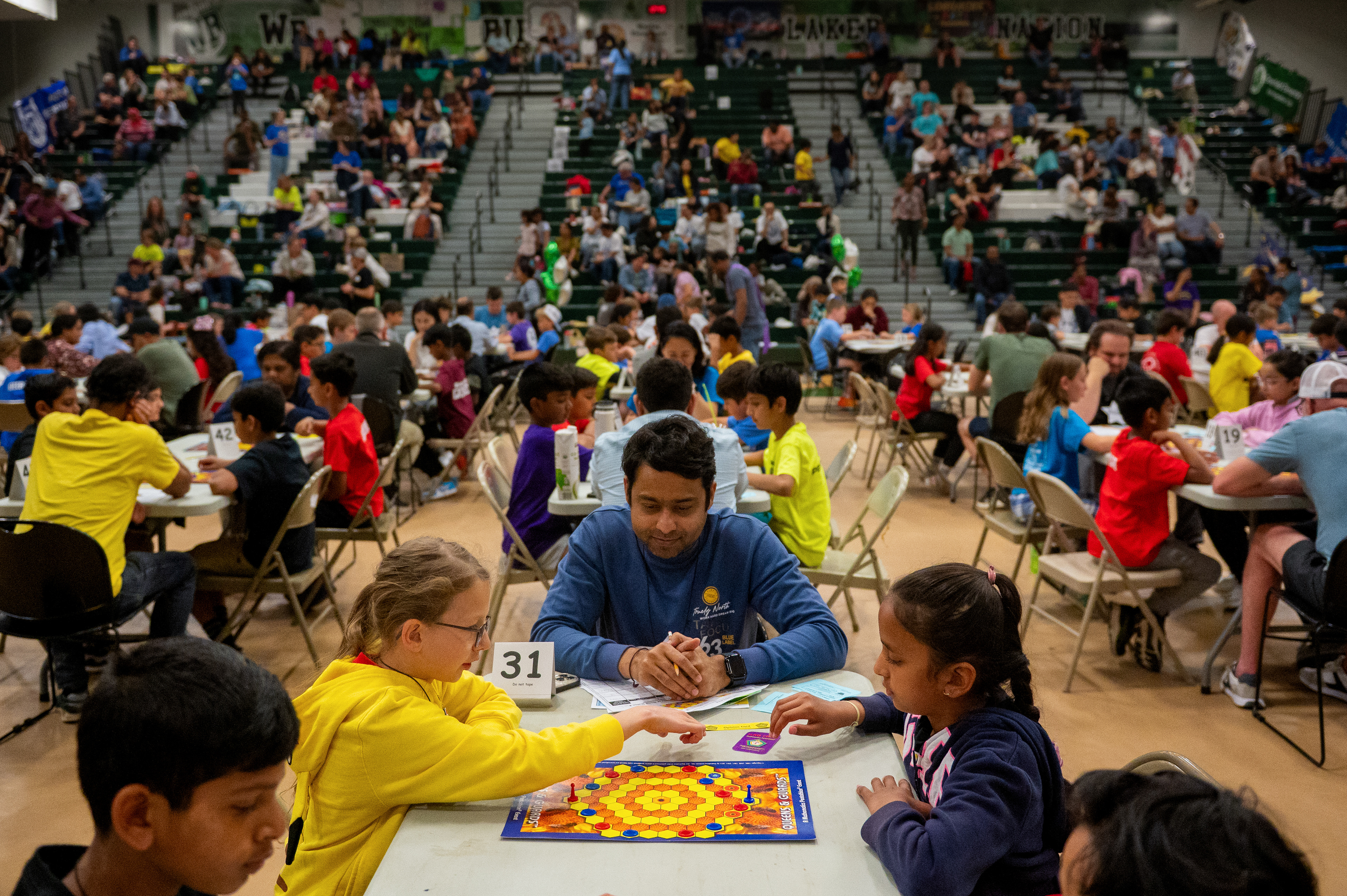 Omar Khan, 42, of West Bloomfield, judges a “Quest and Grids” tournament run by Math Pentathlon at West Bloomfield High School in West Bloomfield, Michigan , on Saturday, May 17, 2025.