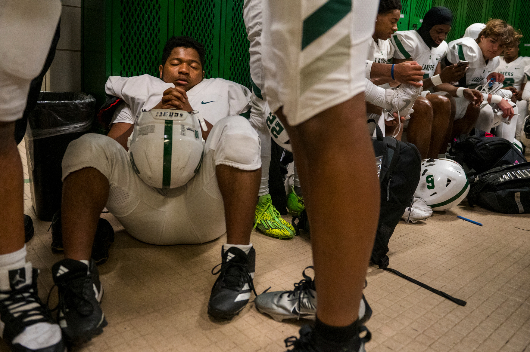 Senior offensive lineman Nicholas Mars (80) of West Bloomfield High School recites prayers in the locker room before a first-round playoff game against the Novi Wildcats at Novi High School in Novi, Mich., on Friday, Nov. 1, 2024. Mars, known for his pregame ritual, prays before every game for good luck and guidance on the field.
