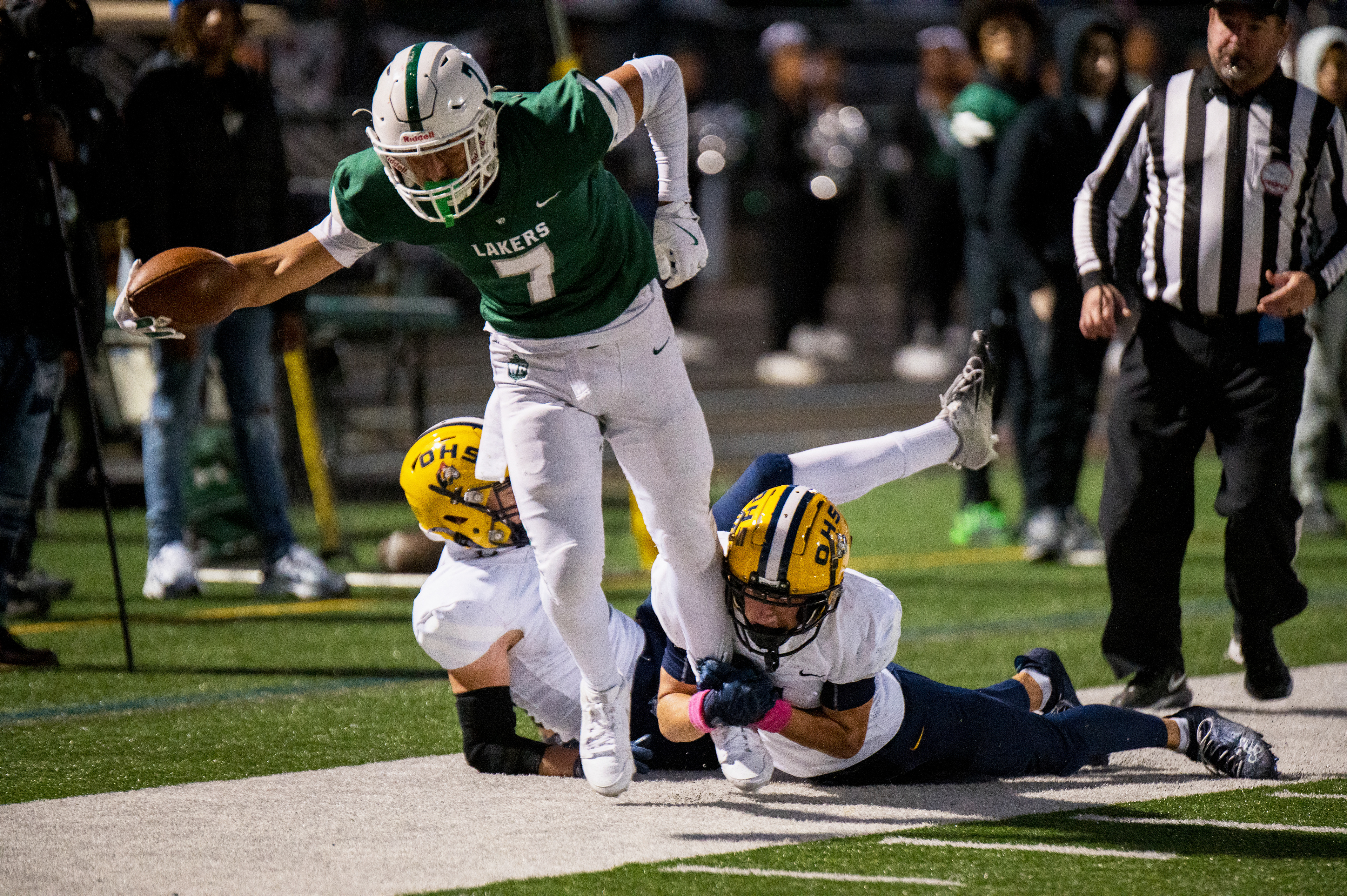West Bloomfield wide receiver and linebacker Jaiden Allos (7) is tackled by an Oxford defender during the second quarter at West Bloomfield High School in West Bloomfield, Mich., on Friday, Oct. 10, 2024. The Lakers lost 38-14.