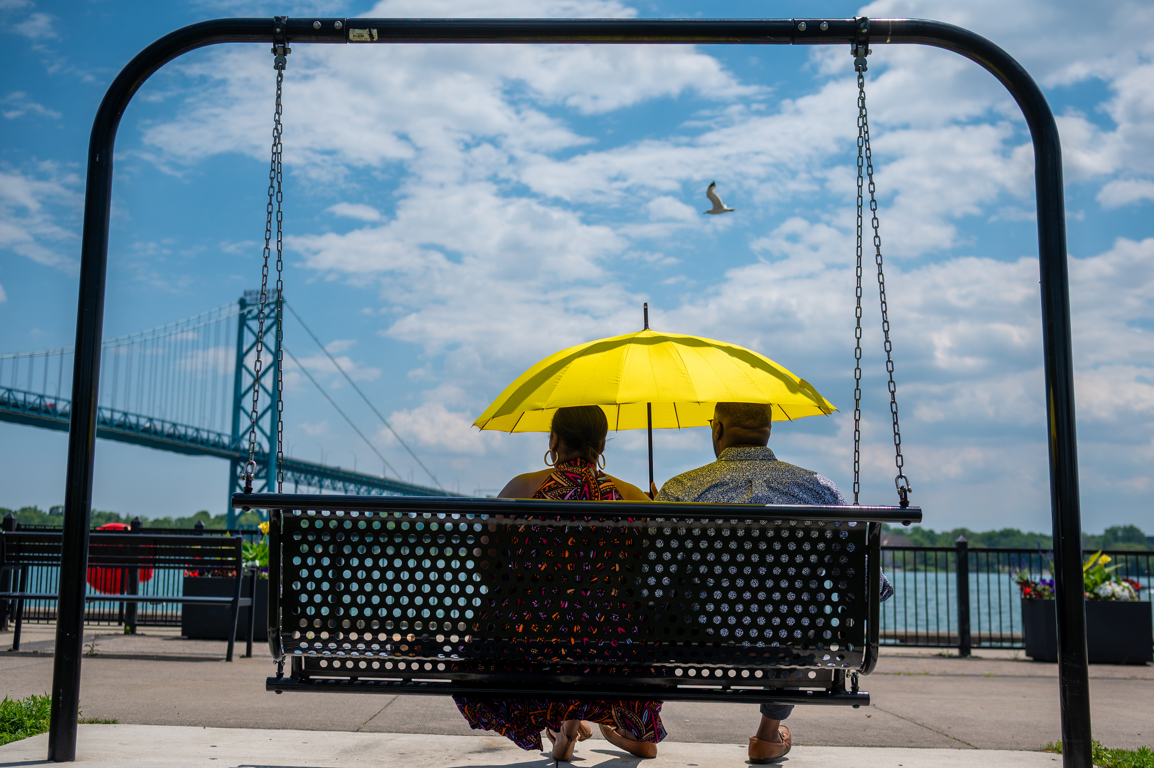Stephanie Umachi, 38, left, and her husband Samuel Umachi, 39, enjoy a day off by the Detroit River at Riverside Park in Detroit on Thursday, August 3, 2025. “It is nice to see the city have resources like this one to spend time in” said Samuel Umachi. 