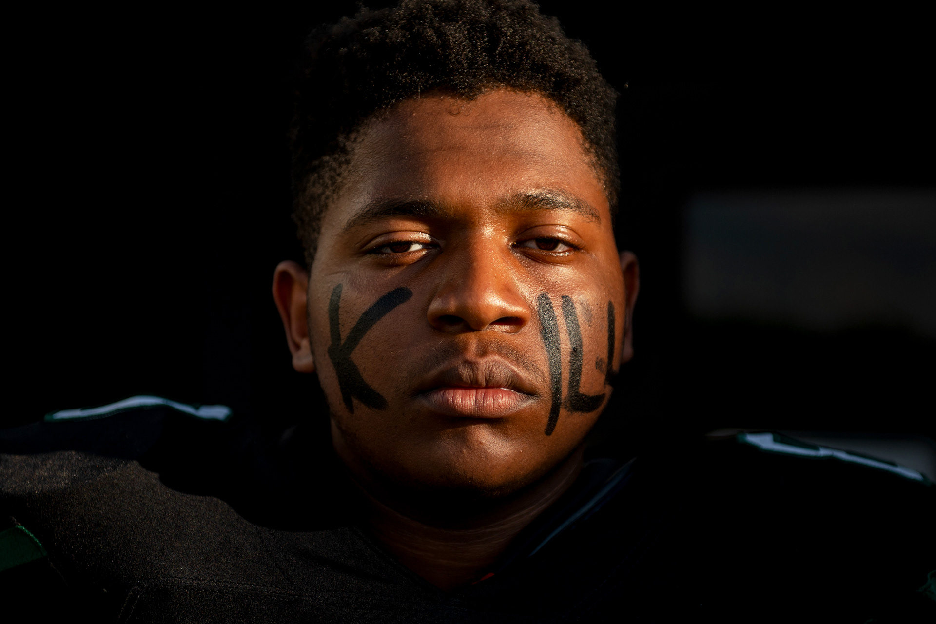 Senior offensive lineman Nicholas Mars (80) of West Bloomfield High School wears eye black reading “KILL” before the Lakers’ homecoming game against Southfield A&T at West Bloomfield High School in West Bloomfield, Mich., on Friday, Sept. 20, 2024. “I don’t think I’m that scary,” Mars said with a grin as the team prepared for the matchup.