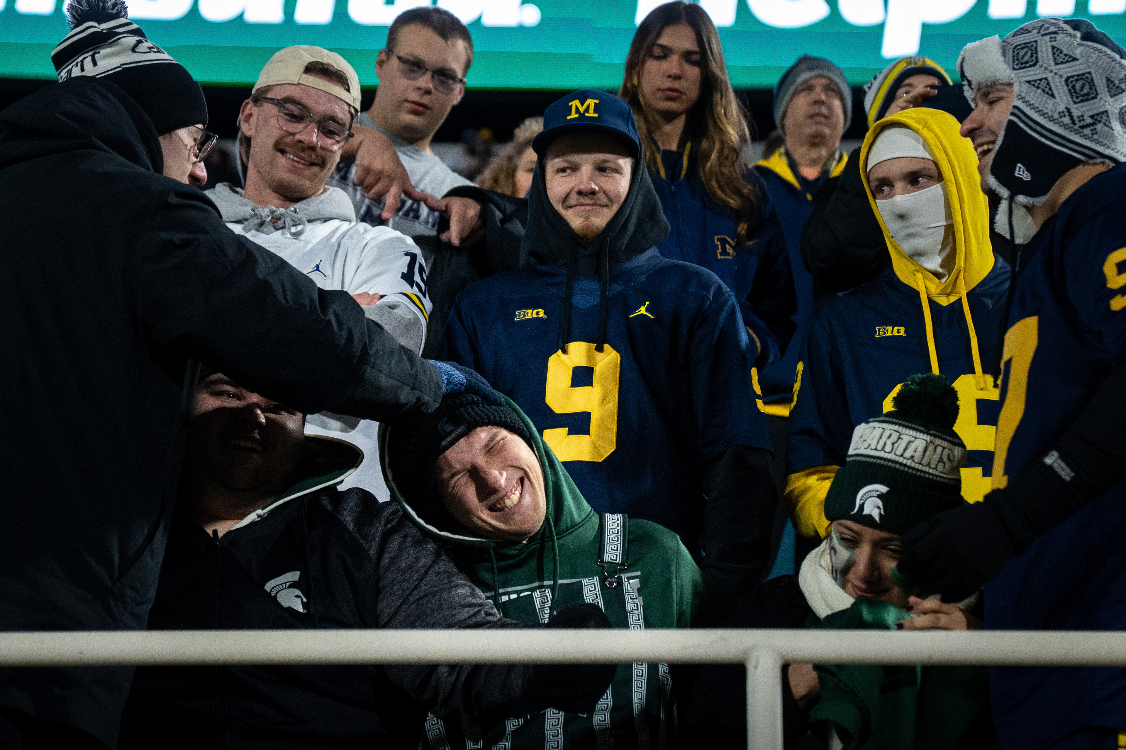 Michigan fans rough house with Michigan State fans after the Michigan State University verses University of Michigan at Spartan Stadium in East Lansing, Michigan, on Saturday, Oct. 25, 2025. 