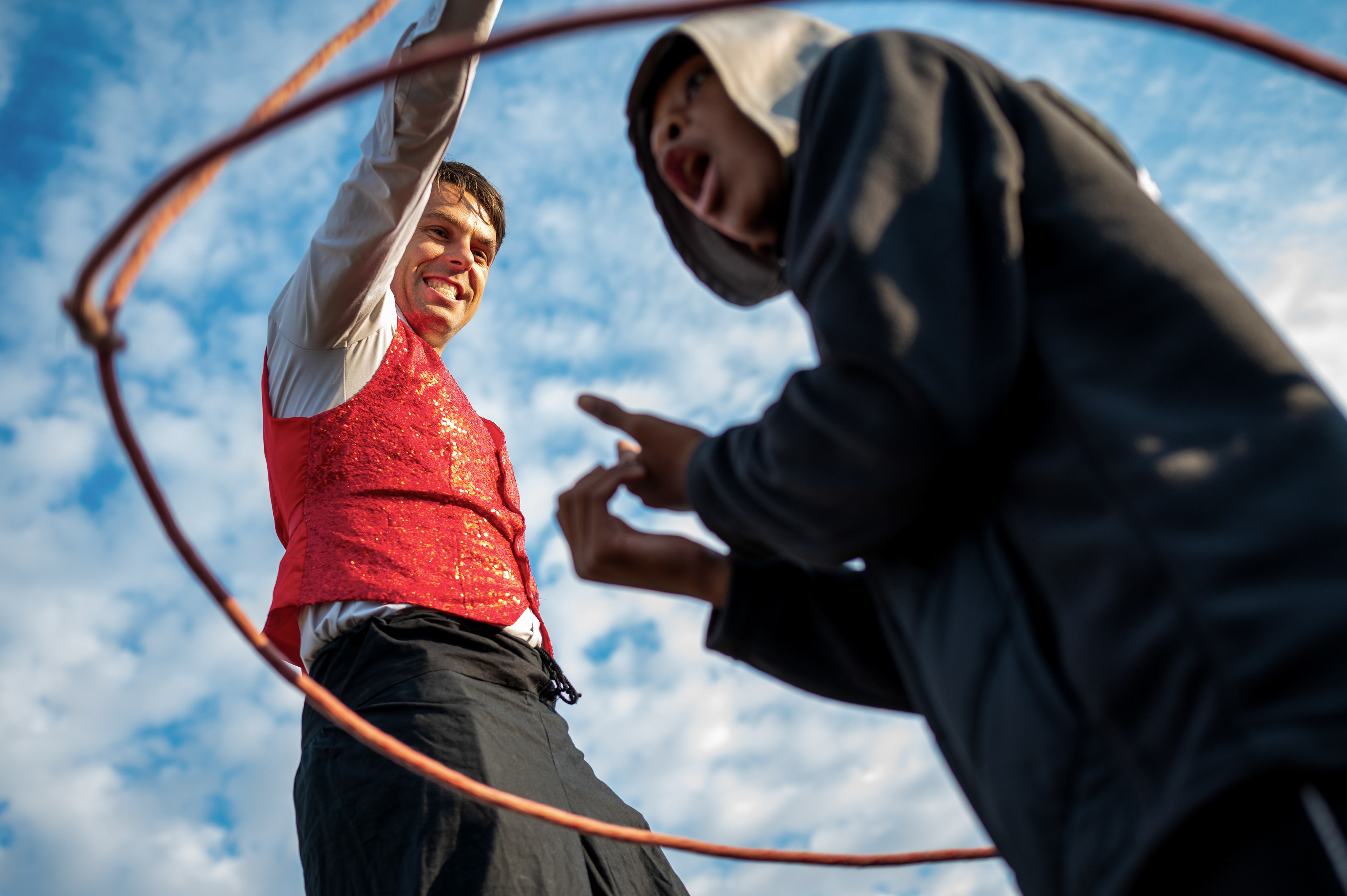 Chuck Clark of Detroit Circus lassos Mikah Davis, 12, of Detroit on Saturday, Oct. 18, 2025 on Atwater Street and the Detroit Riverwalk area during the 48th annual Detroit Free Press Marathon events presented by MSU Federal Credit Union.