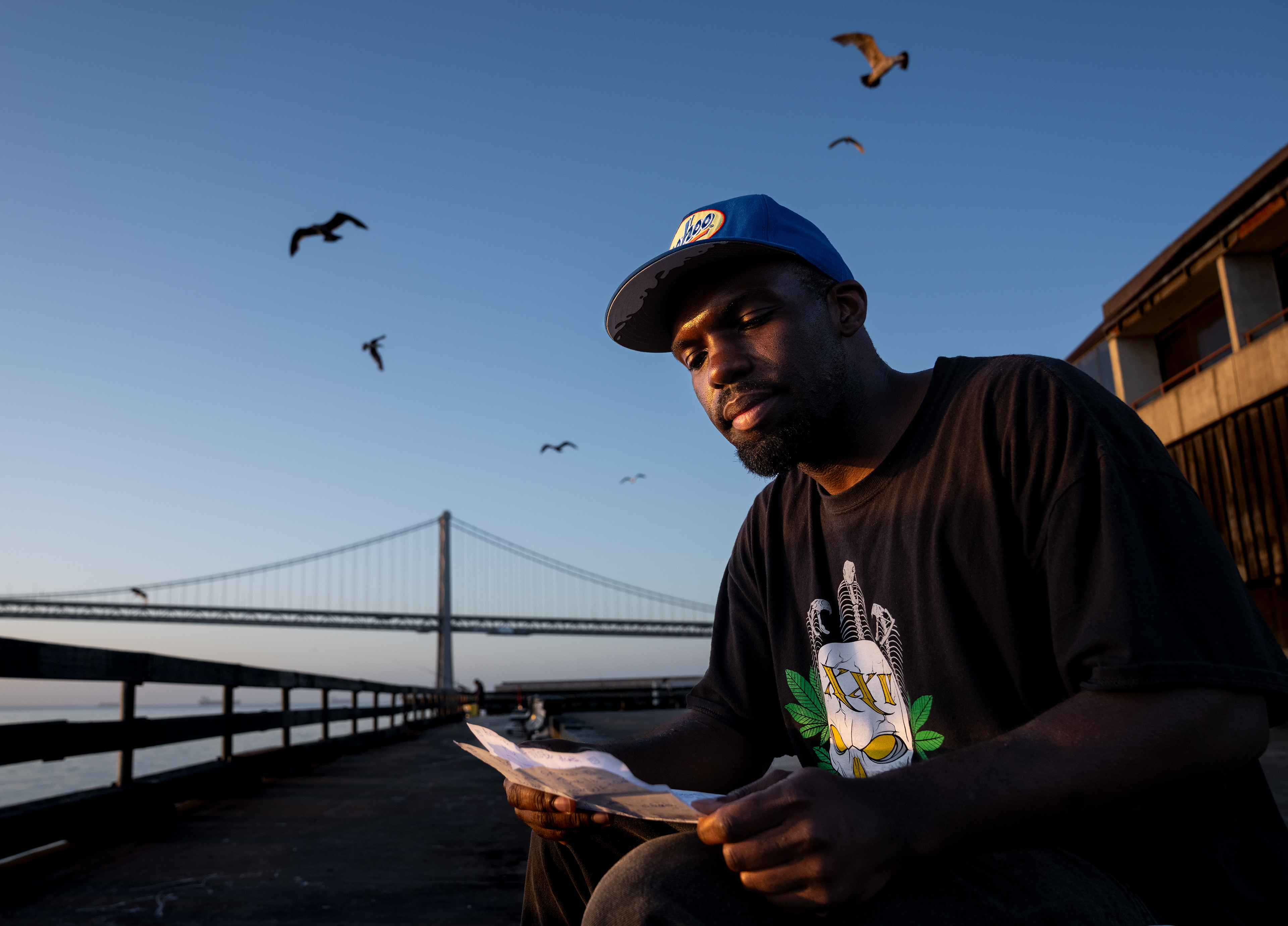 Freddy Nicholson, 29, reads a manifesto he wrote about getting sober outside the Ferry Building on the morning of Sunday, May 31, 2026, in San Francisco, California. Written on the first day of his recovery from drug addiction, the manifesto served as a commitment to himself and a reminder of the life he hoped to rebuild. Reading it again years later offered a chance to reflect on the challenges he has overcome and the progress he has made.