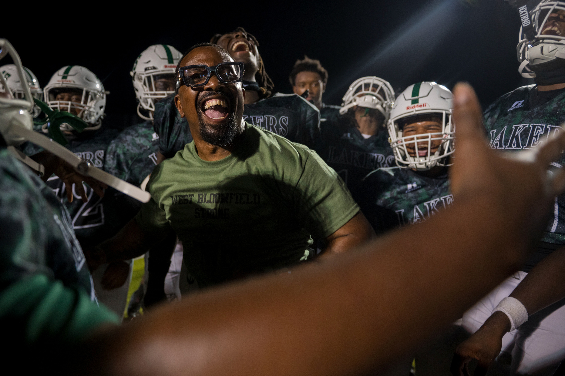 Defensive coach Leron Jones leads West Bloomfield High School players in the team’s signature “L Boyz” chant following a 42-0 victory over Chippewa Valley at West Bloomfield High School in West Bloomfield, Mich., on Thursday, Aug. 29, 2024. “This is just the beginning - we’re getting that ring,” Jones said.