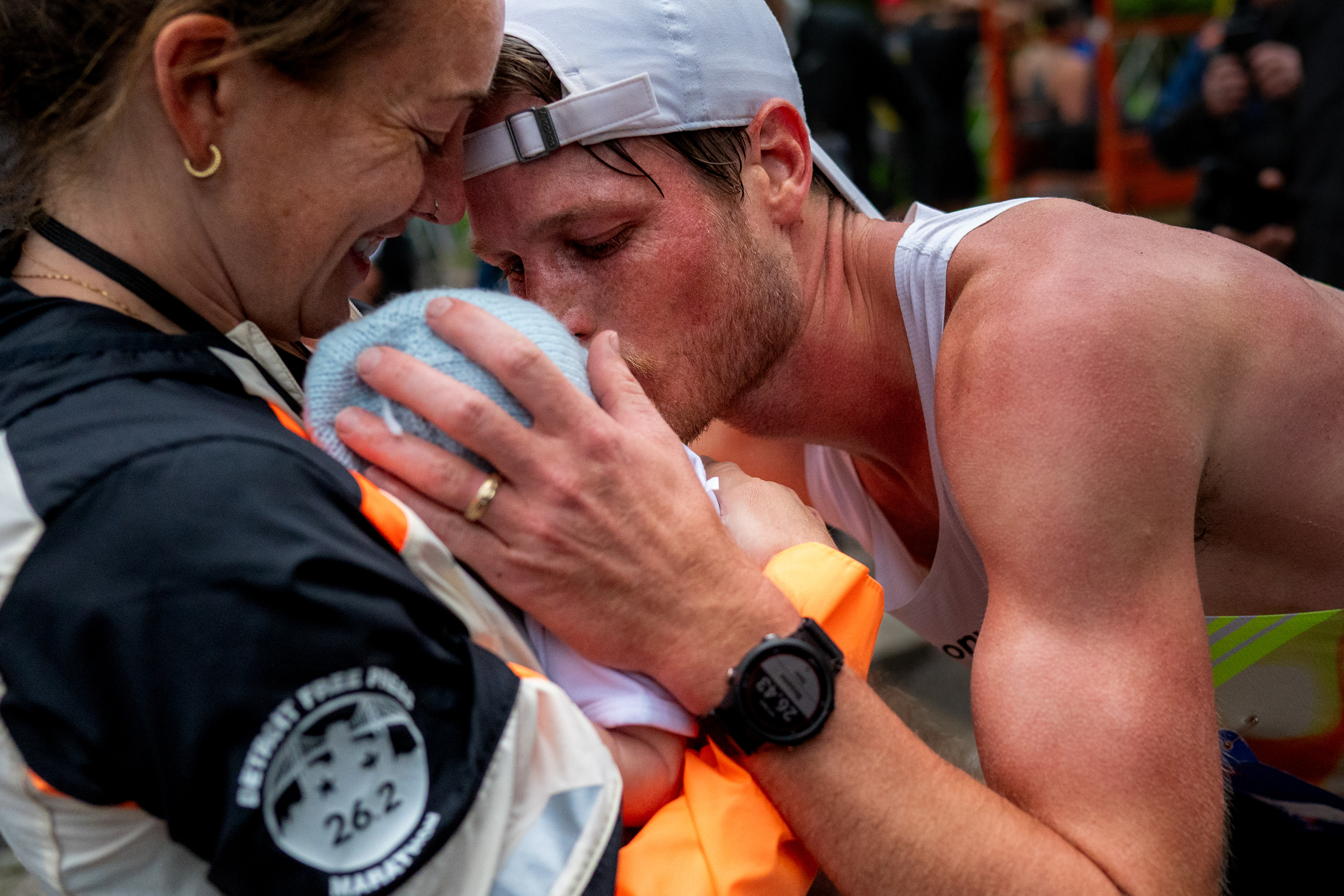 Andy Bowman wins the male marathon race and embraces his wife Sydney Devore-Bowman and their 3-week-old son Liam during the 48th annual Detroit Free Press Marathon presented by MSU Federal Credit Union in Detroit on Sunday, Oct. 19, 2025.
