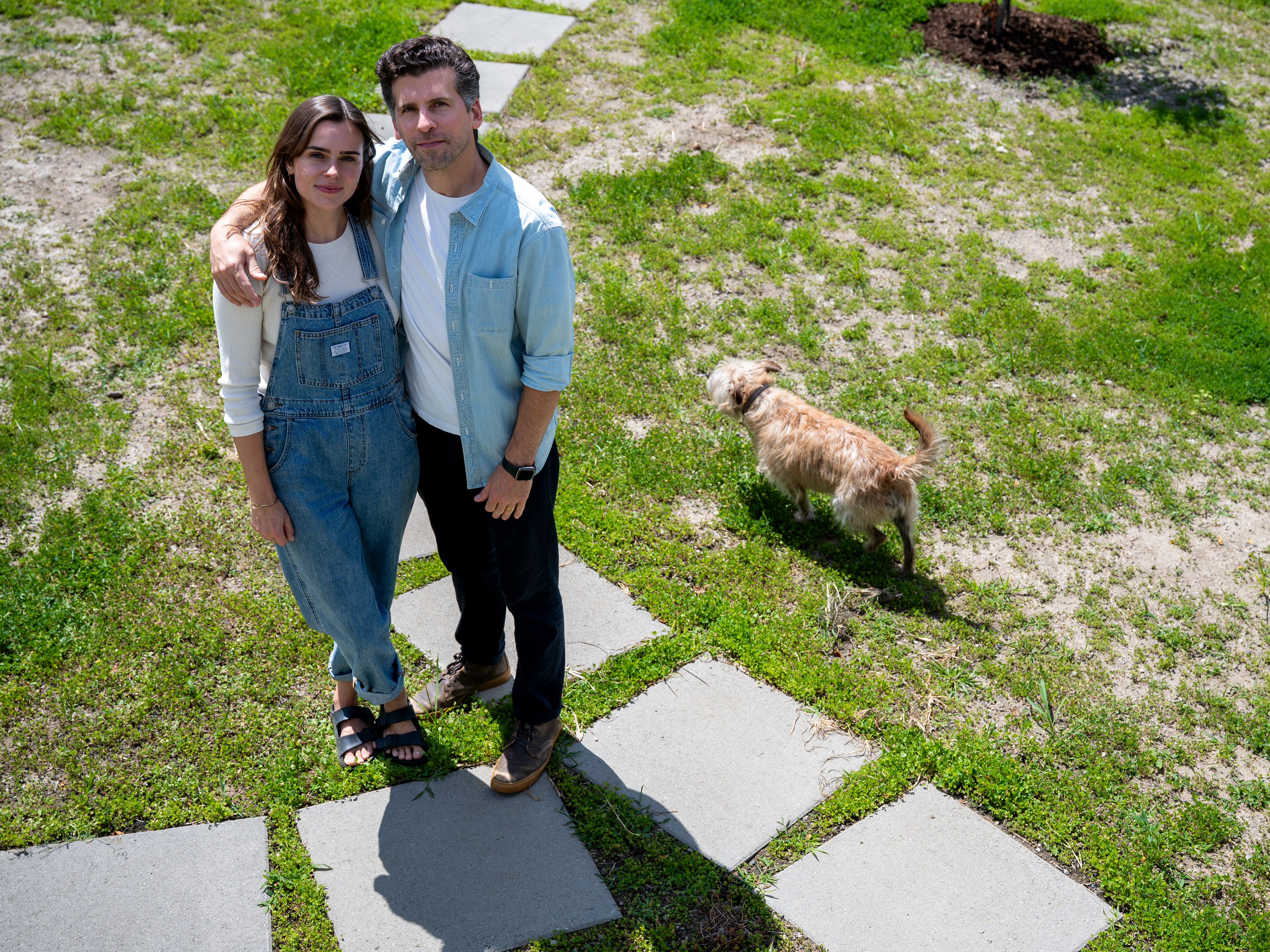 John Boros, 40, owner of Keylight Development and homeowner, stands with his wife, Meg Lockhart, 33, and their dog, Walter, outside their new-construction home in Detroit’s Islandview neighborhood on Thursday, July 23, 2026.