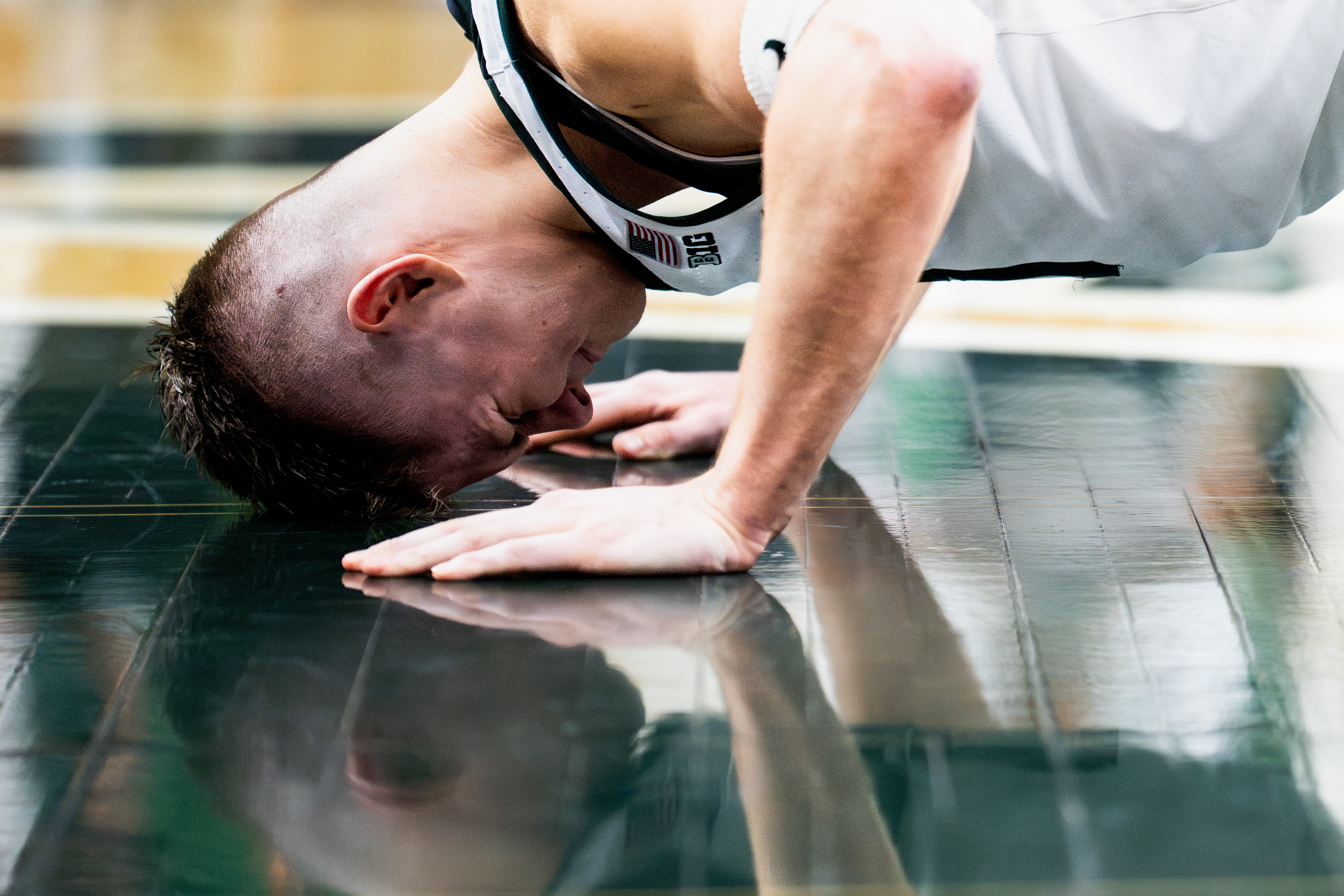 Michigan State Spartans forward Jaxon Kohler (0), rests his head on the Spartan logo following the floor-kissing ceremony celebrating senior night after the Michigan State Spartans faced the Rutgers Scarlet Knights in a men’s basketball game at the Breslin Center at Michigan State University in East Lansing, Mich., on Thursday, March 5, 2026.